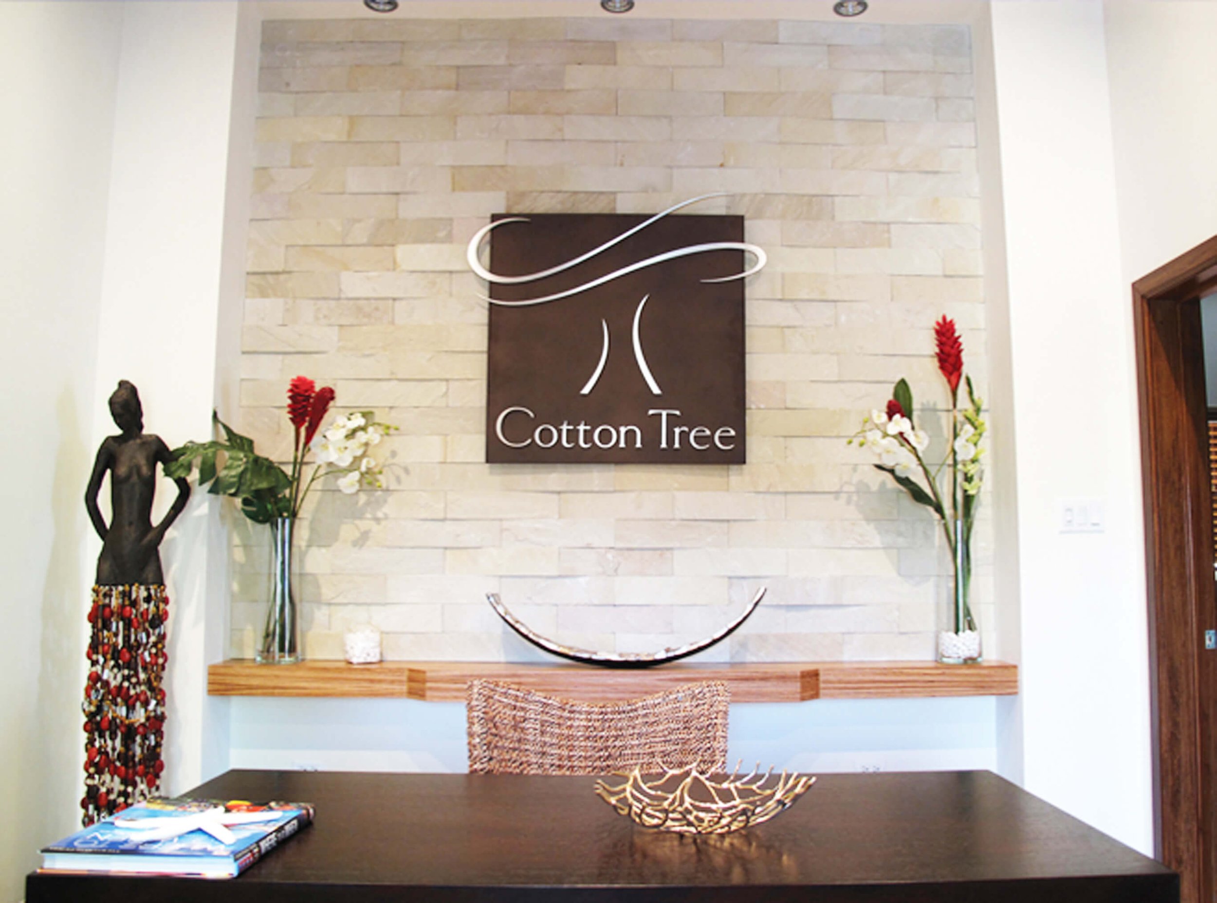 Reception area at Cotton Tree Grand Cayman with natural materials and coastal styling.
