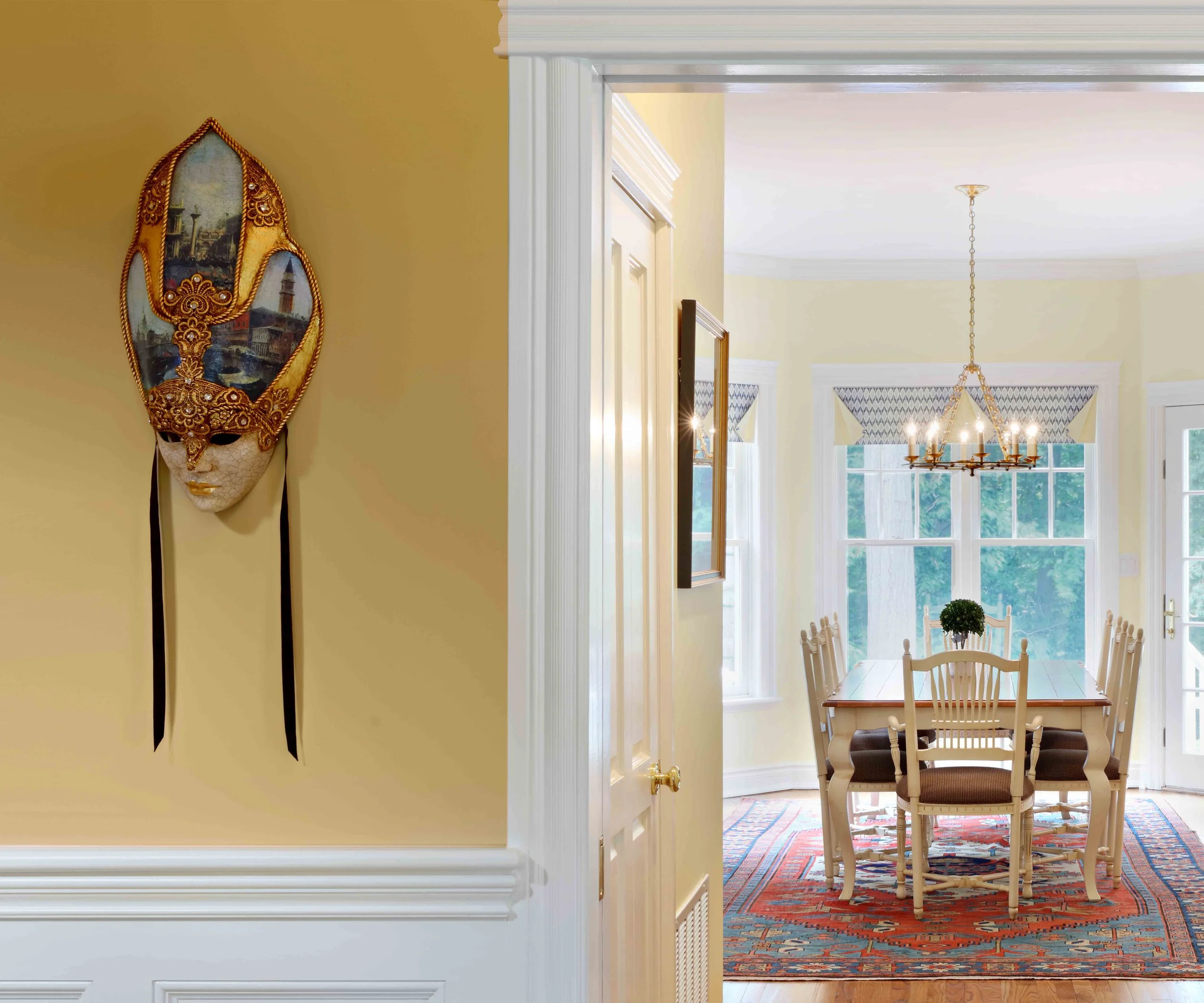 Foyer featuring decorative venetian mask at Lismore House in Greenwich, CT.