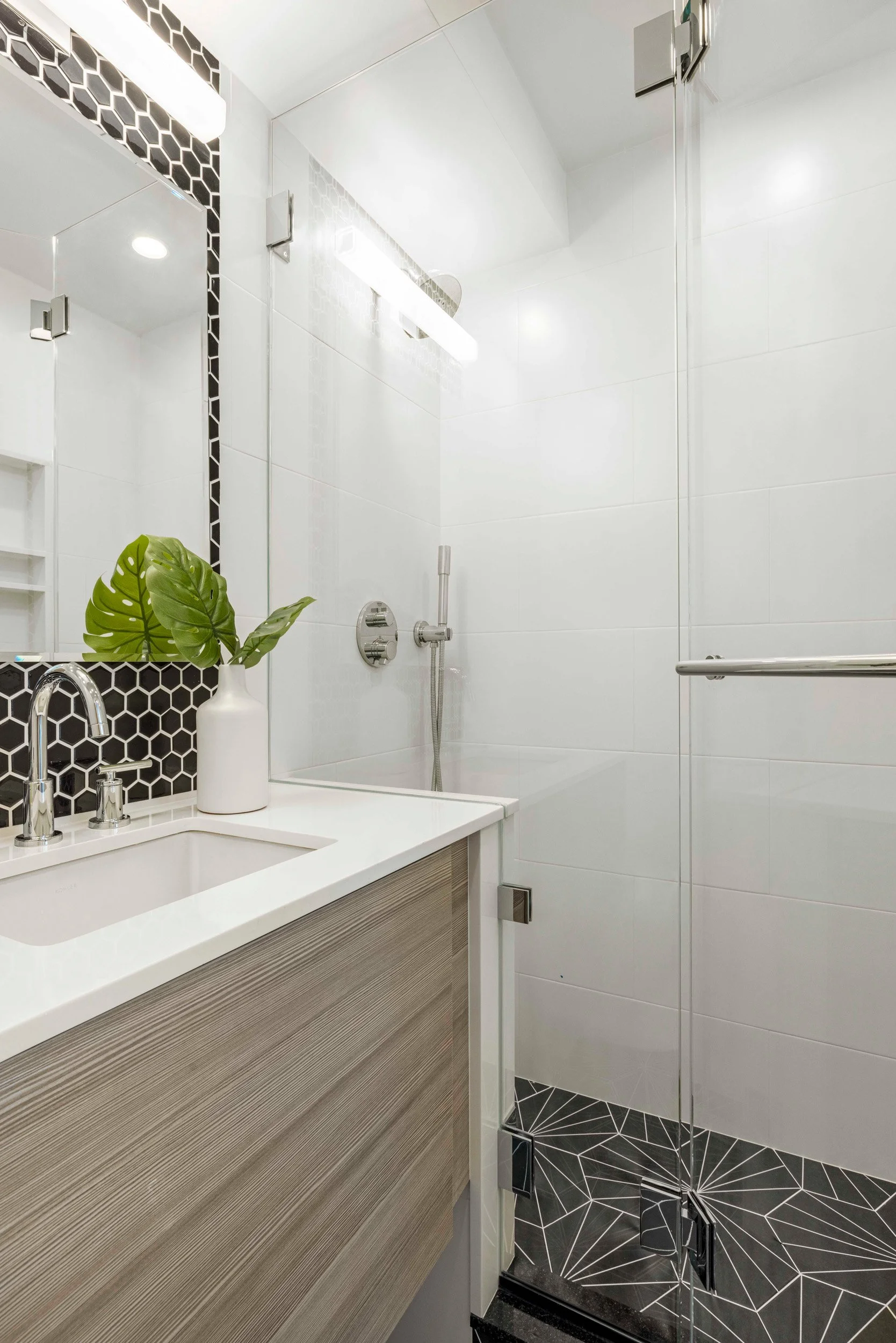 Close-up of the bathroom vanity and shower in the Gramercy Arms apartment, NYC by Luminosus Designs.