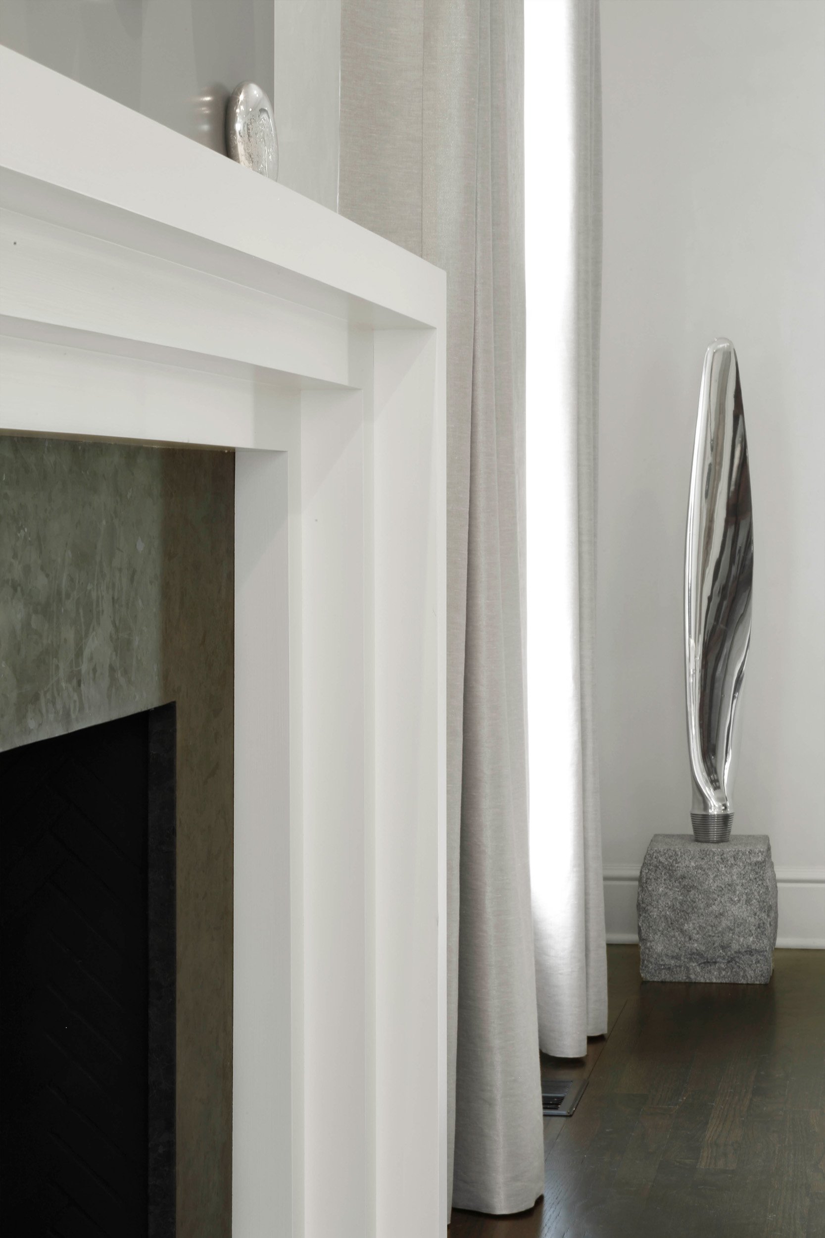 Living room at the Meeting House in Greenwich, CT with a modern fireplace wall, layered seating, and soft neutral finishes.