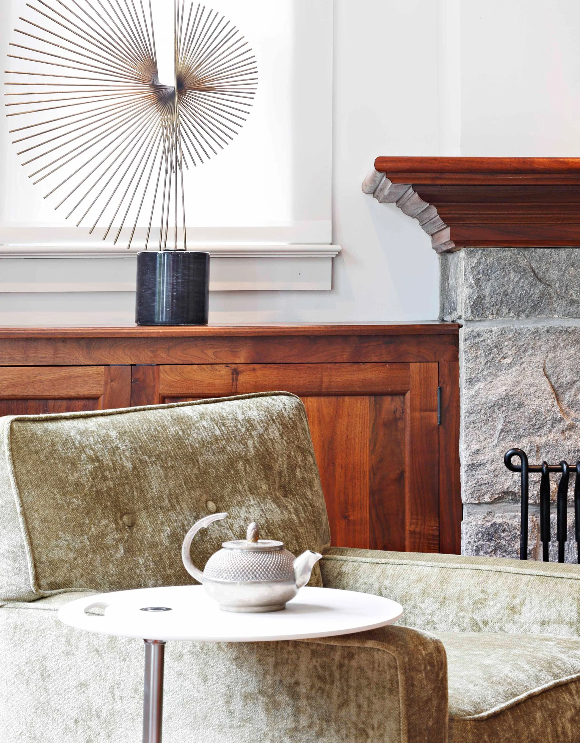 Close-up of lounge chair with adjustable side table for flexible seating in Indian Field residence in Greenwich, CT.