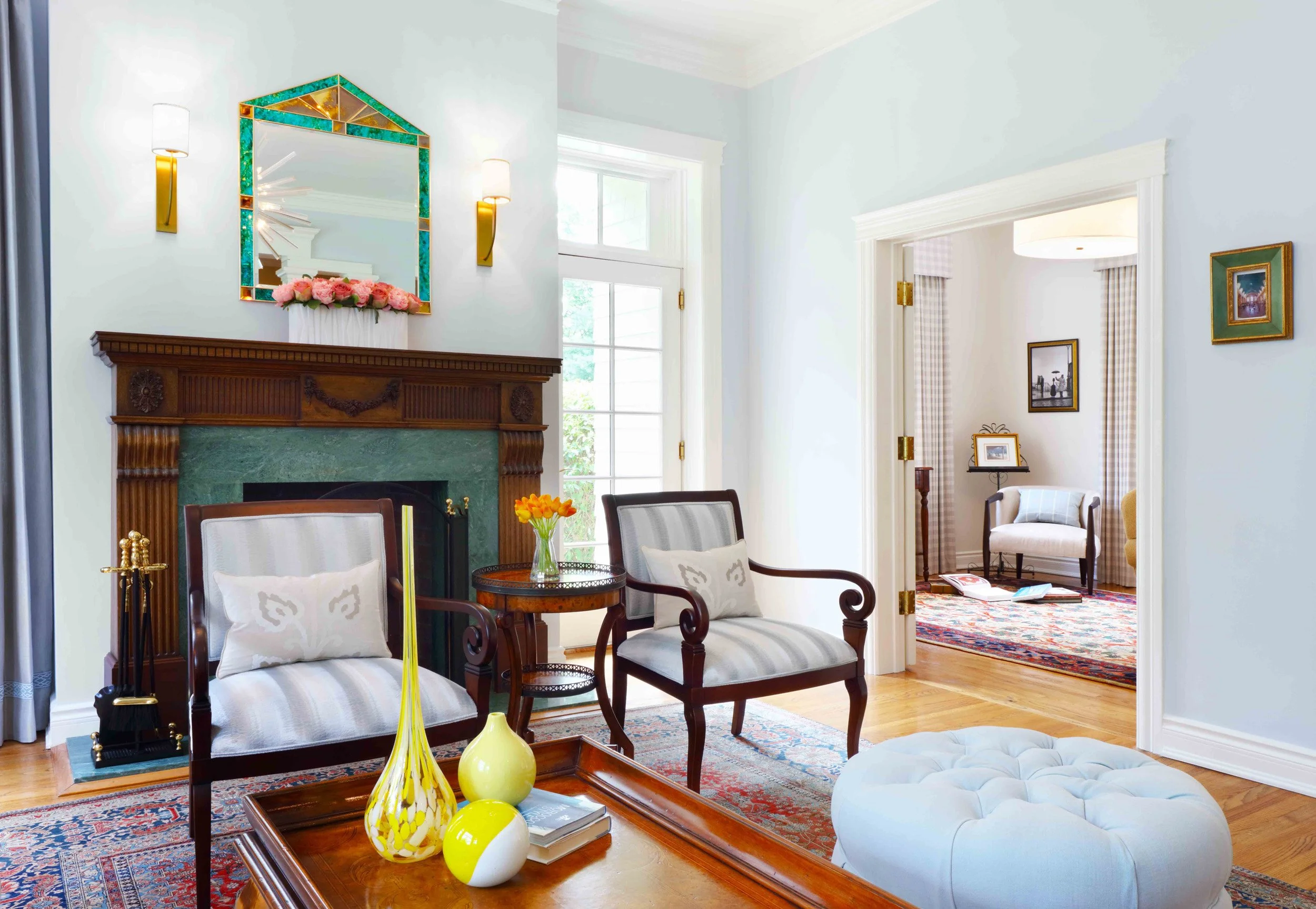 Living Room featuring upholstered ottoman and table at Lismore House in Greenwich, CT.