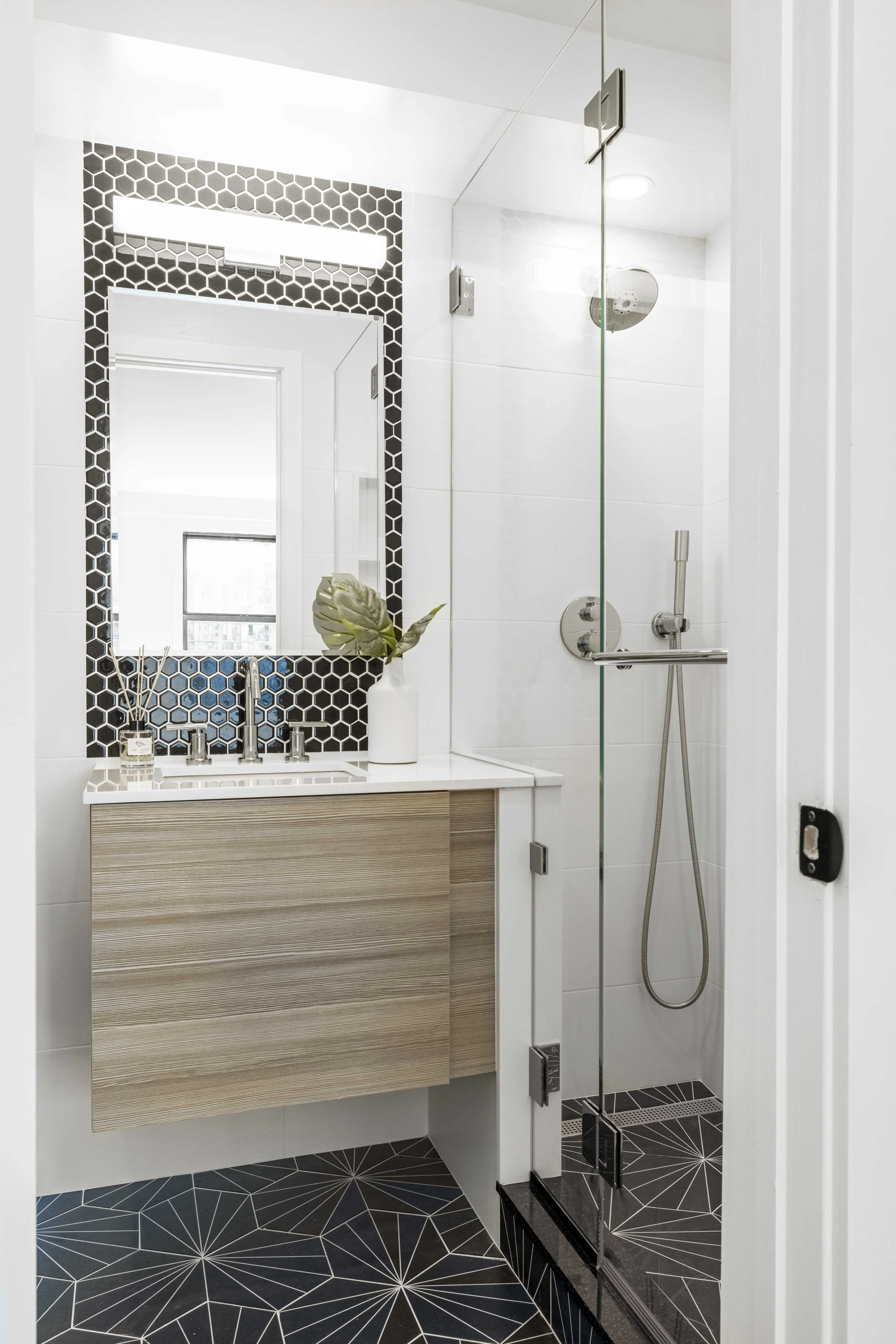 Close-up view of the Gramercy Arms bathroom, showing a compact yet functional vanity with clean finishes.