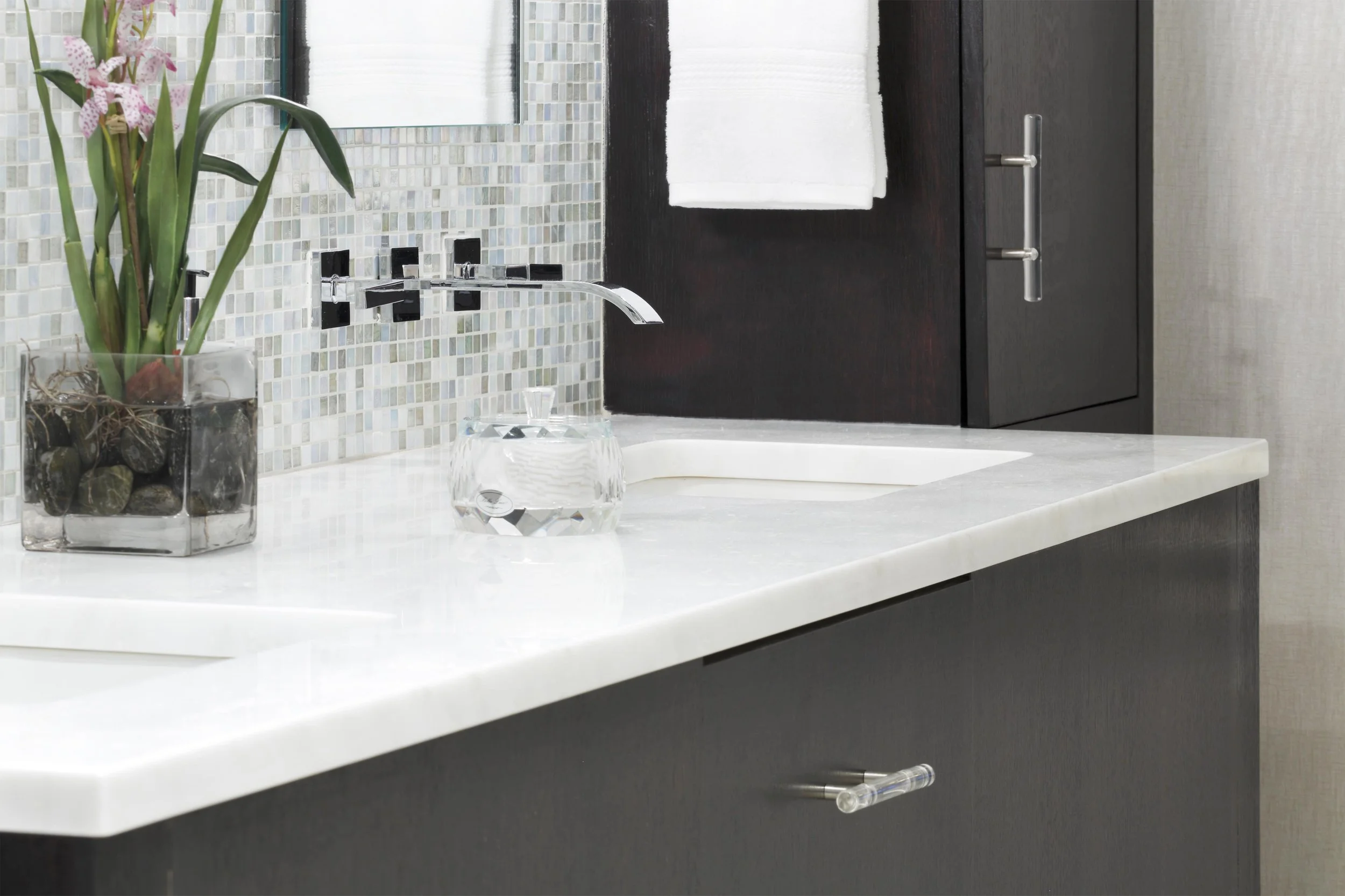 close-up view of the wall-mount vanity faucet in a primary bathroom in Old Briarcliff, NY.