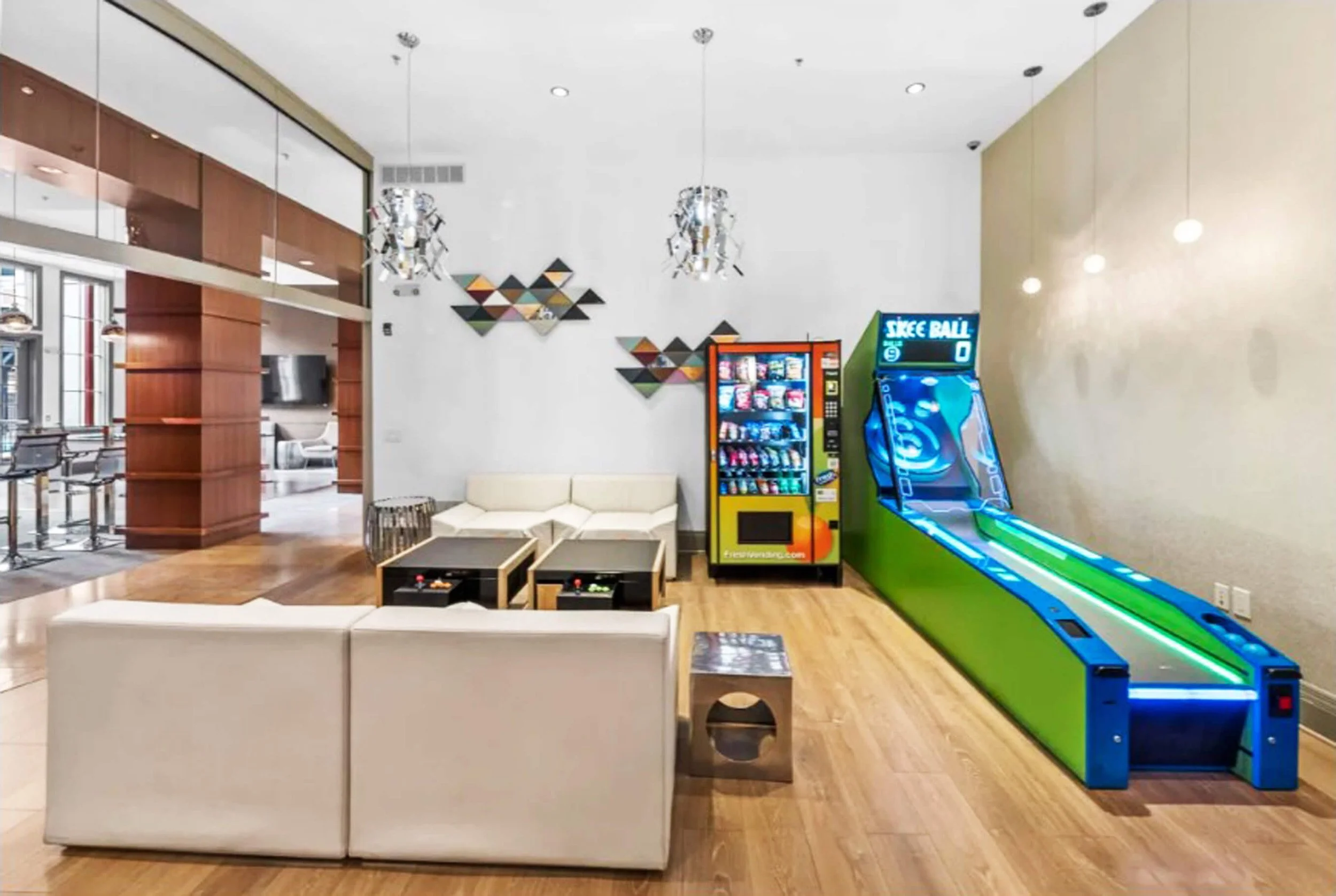 Residential building game room design with seating, arcade elements, and lounge area in Bayonne NJ.