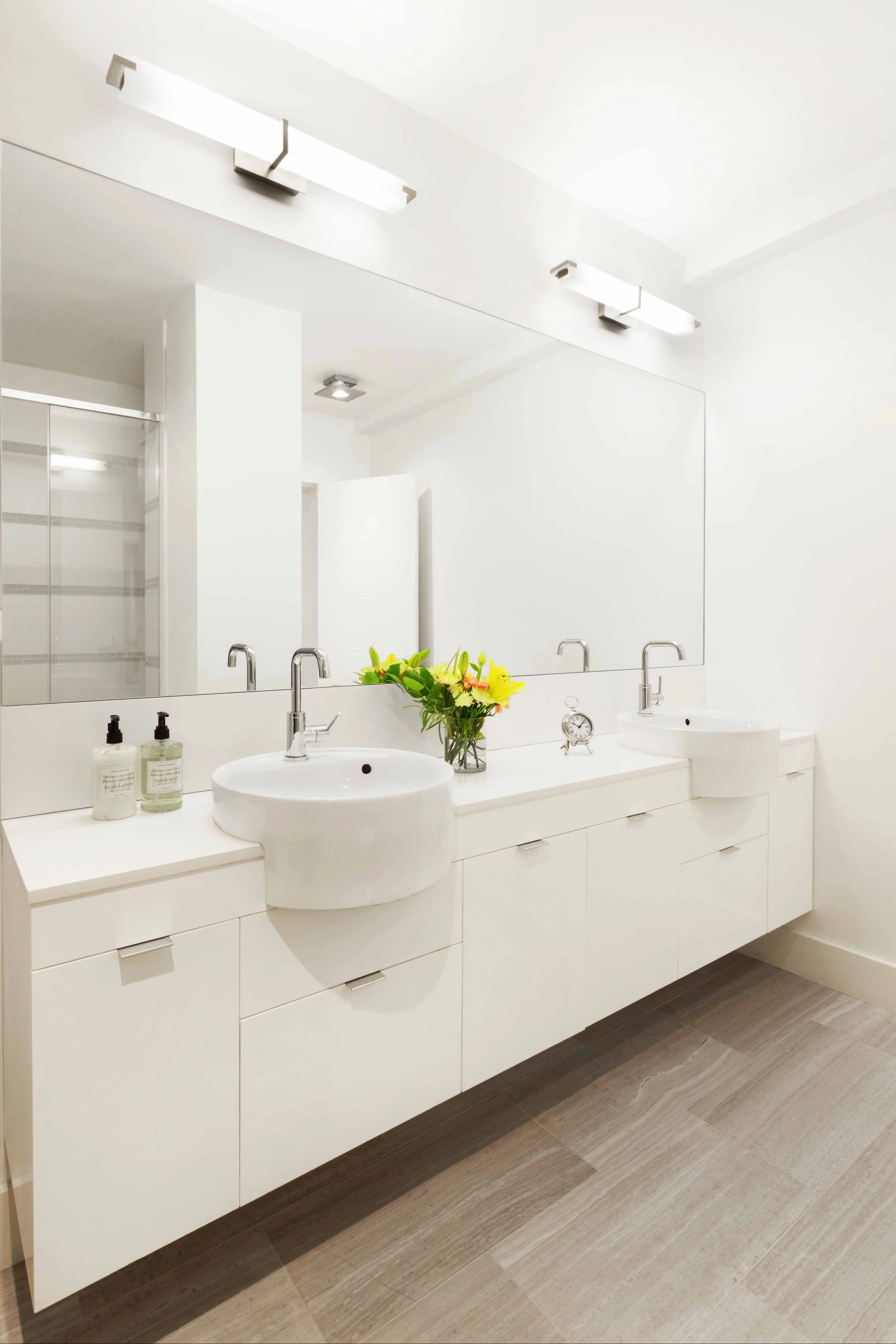 Custom vanity cabinet with vessel sinks in contemporary primary bath in White Plains, NY.