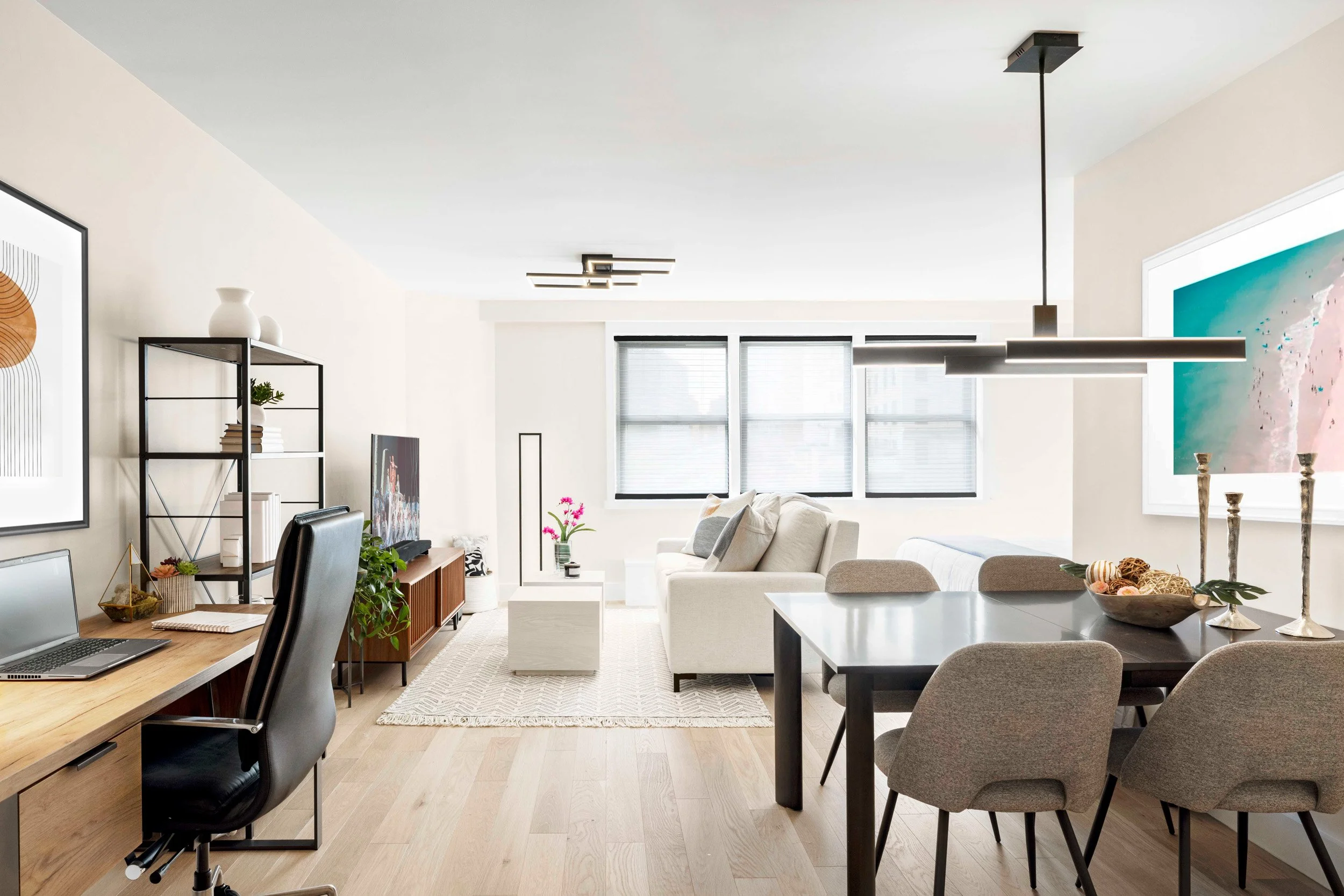 Wide view of the Gramercy Arms apartment in New York City, showing an open floor plan, tailored furnishings, and a calm, sophisticated aesthetic.