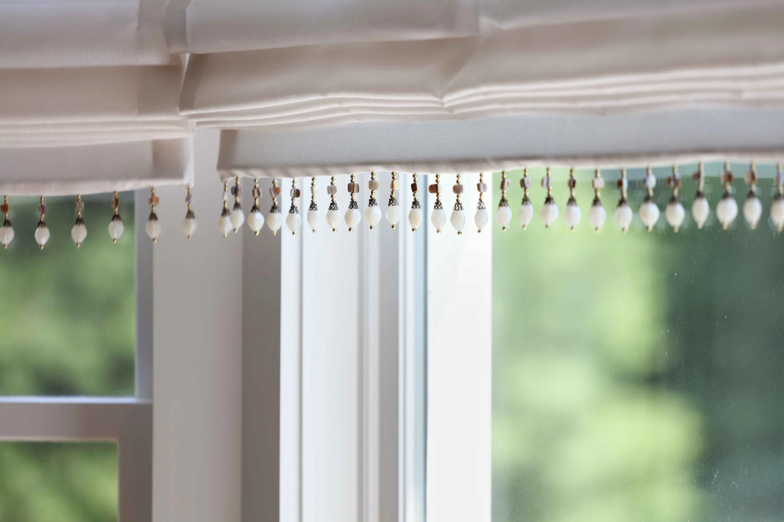 Dining Room featuring delicate window treatment detail at Lismore House in Greenwich, CT.