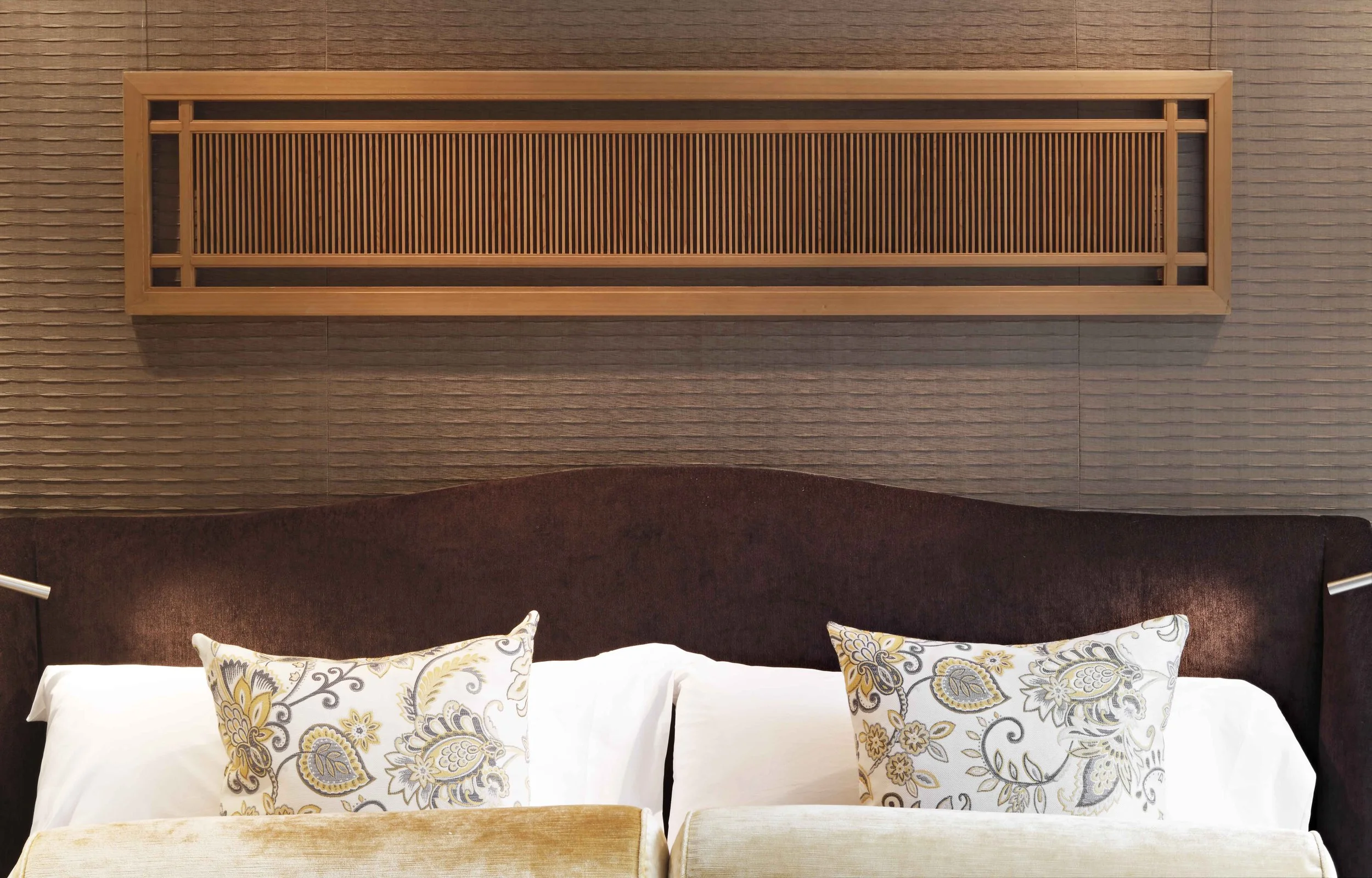 Headboard with antique screen mounted above the bed.