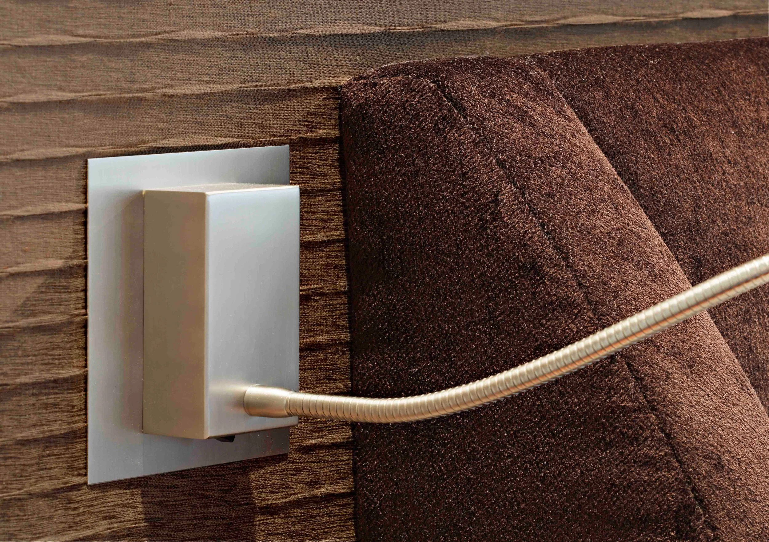 Adjustable reading light mounted beside the bed in primary bedroom in Indian Field residence in Greenwich, CT.