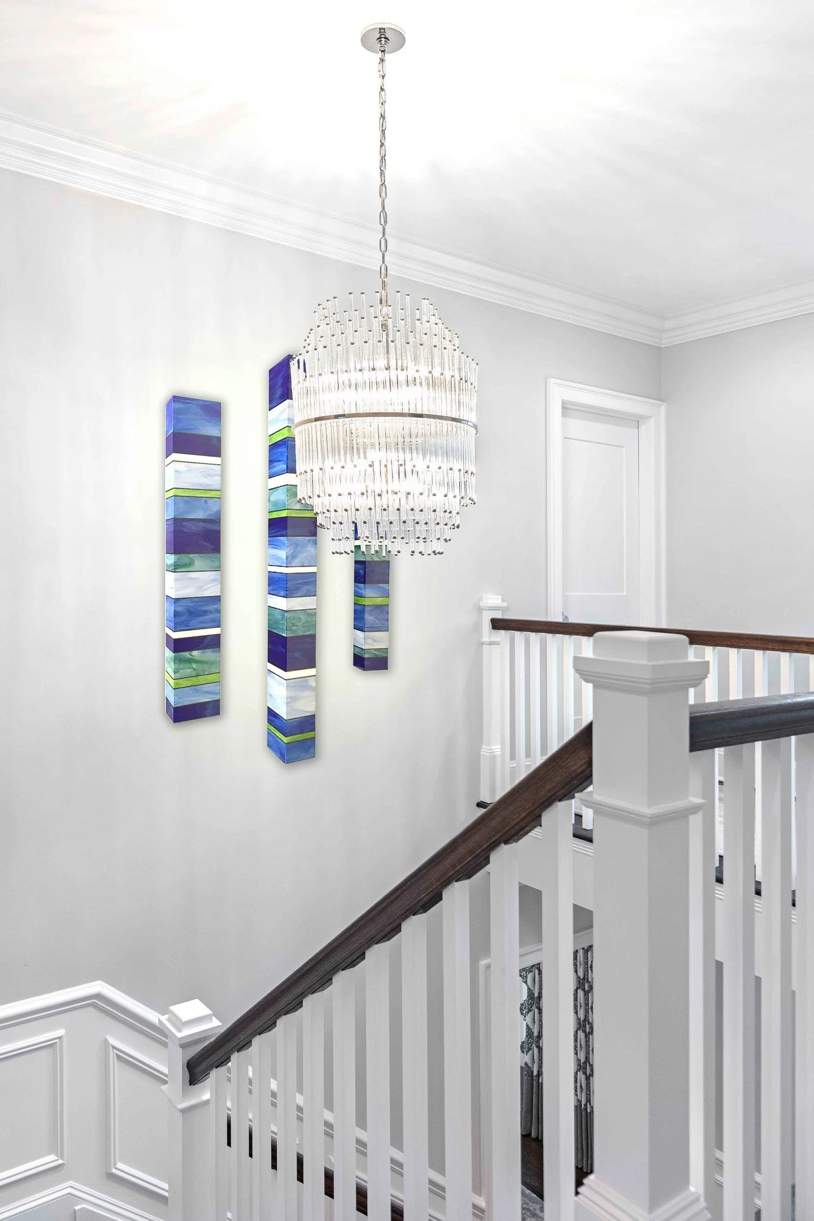 Close-up view of the staircase chandelier in the Glen Oaks, Rye NY home, highlighting craftsmanship and materials.