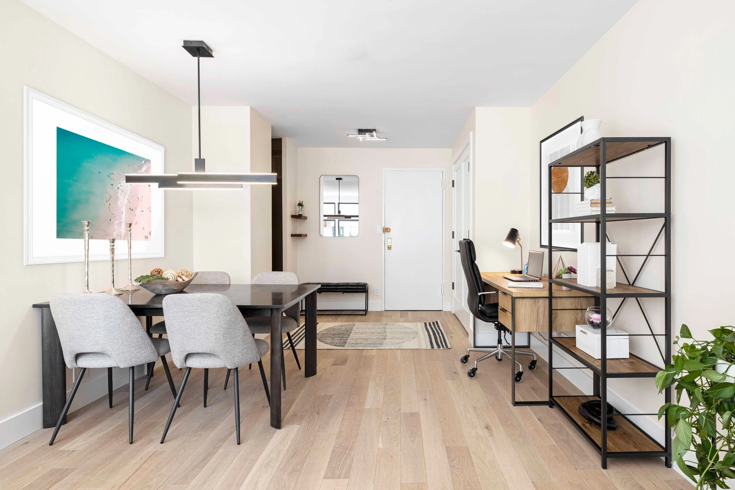 Wide view of the Gramercy Arms apartment in New York City, showing dining area, desk area, and foyer.