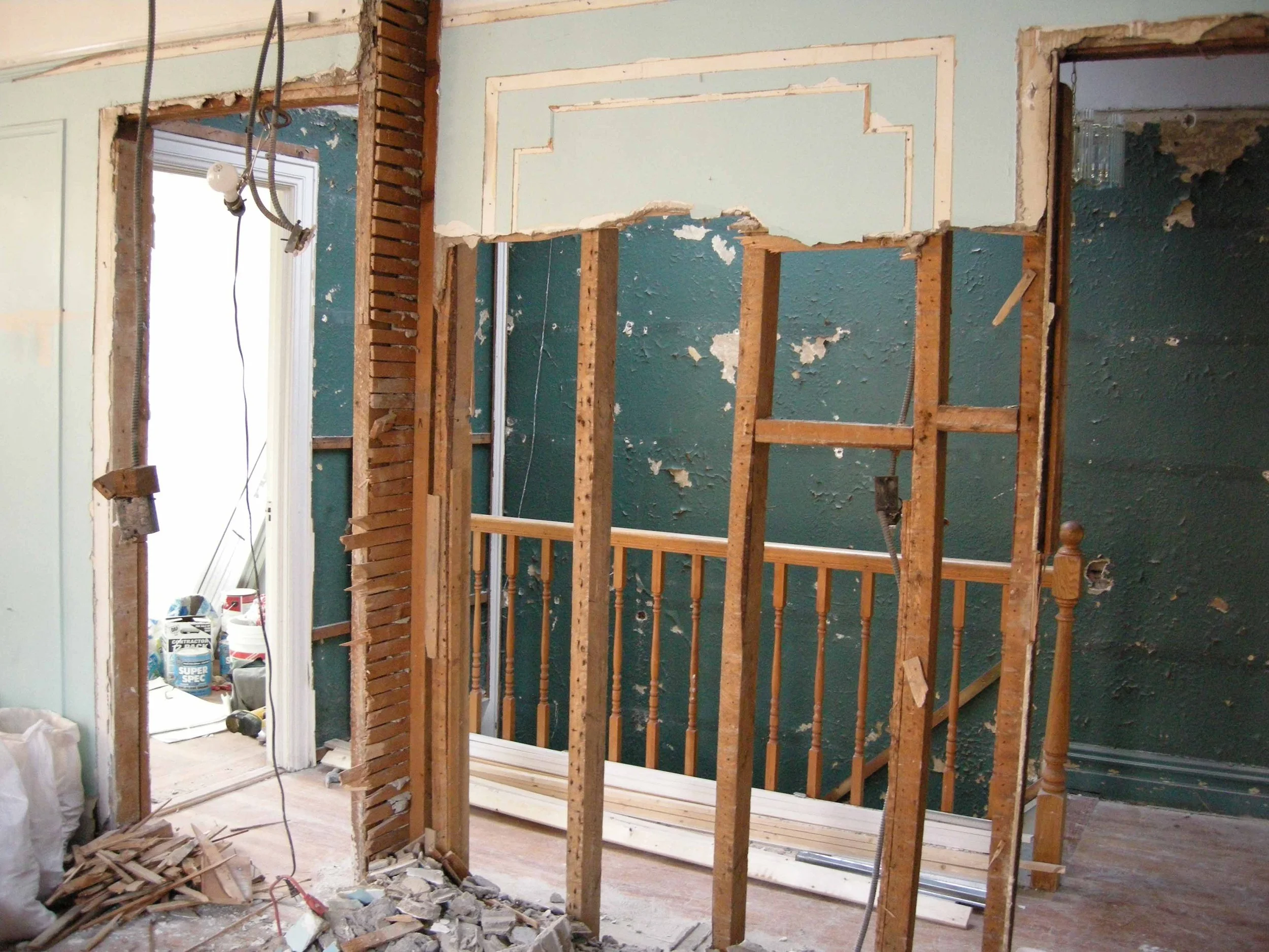 Opened wall during older home renovation revealing hidden framing and existing construction conditions