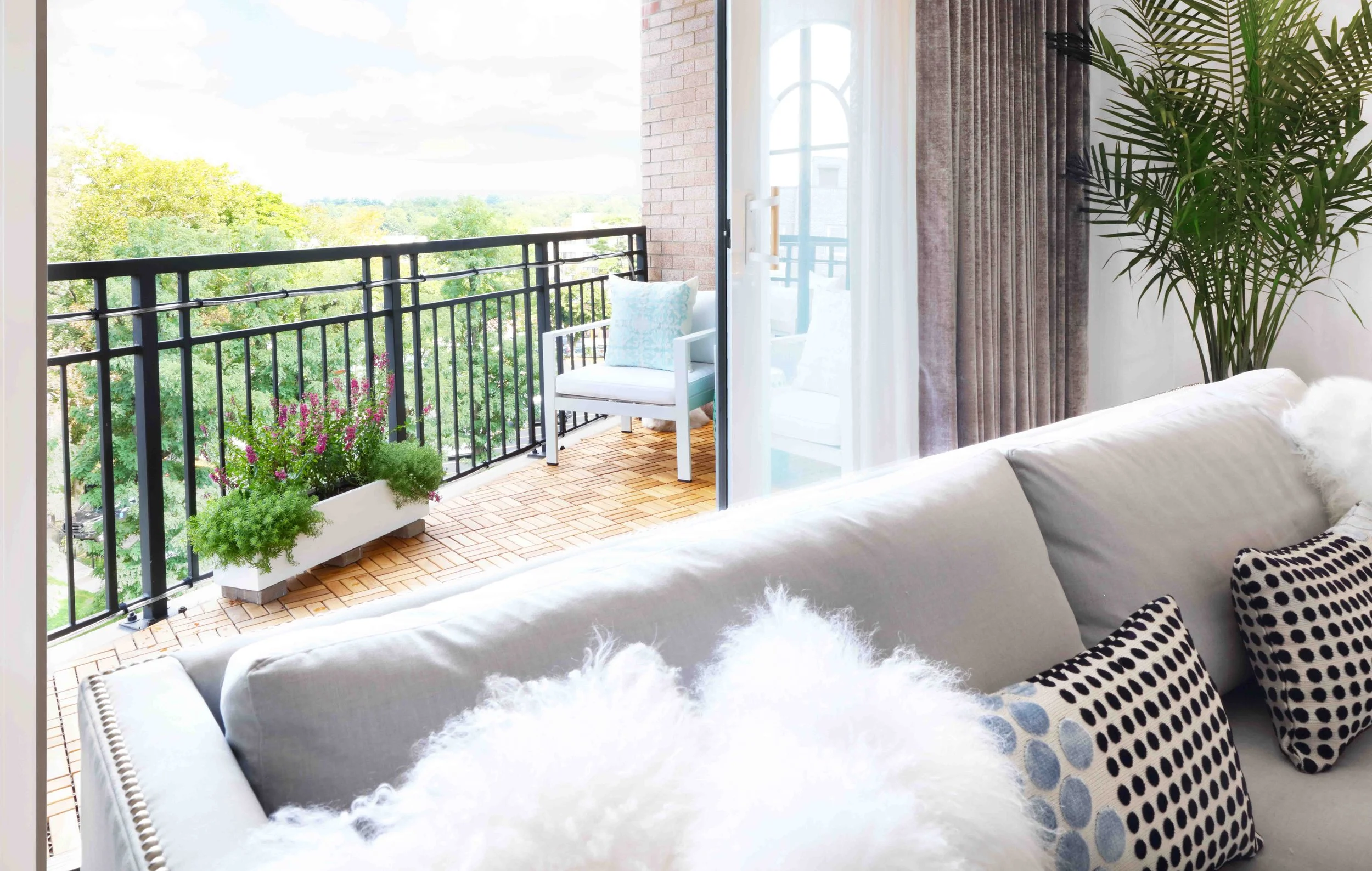 Private apartment balcony with seating and city views in Doyer Apartment in White Plains, NY.