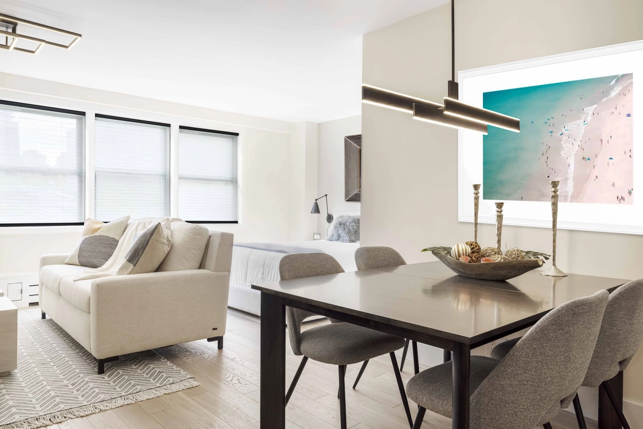 Wide view of the dining area looking into adjacent living area in the Gramercy Arms apartment NYC, showing table placement and circulation.