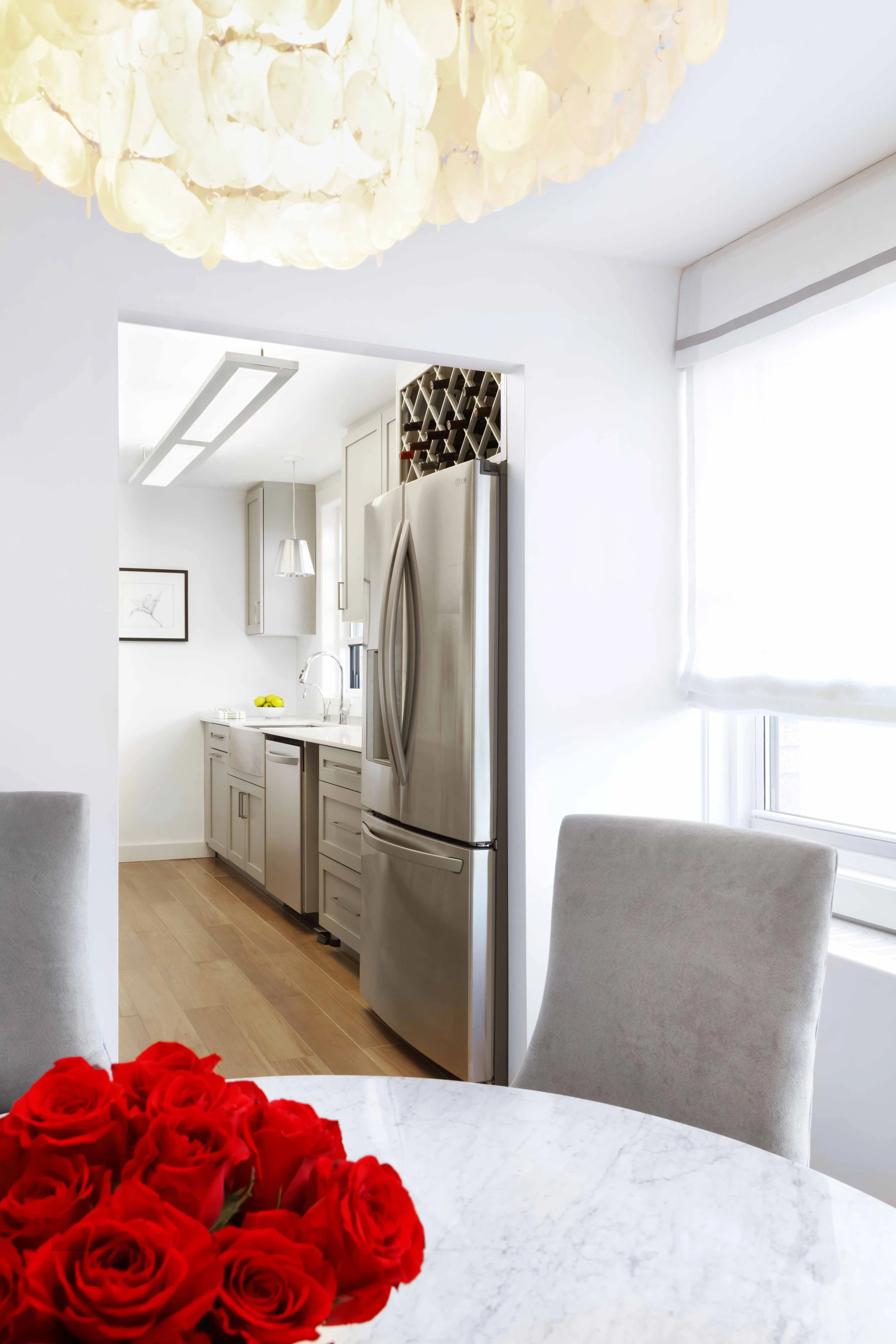 Dining room detail highlighting streamlined chairs and refined finishes in Doyer Apartment in White Plains, NY.
