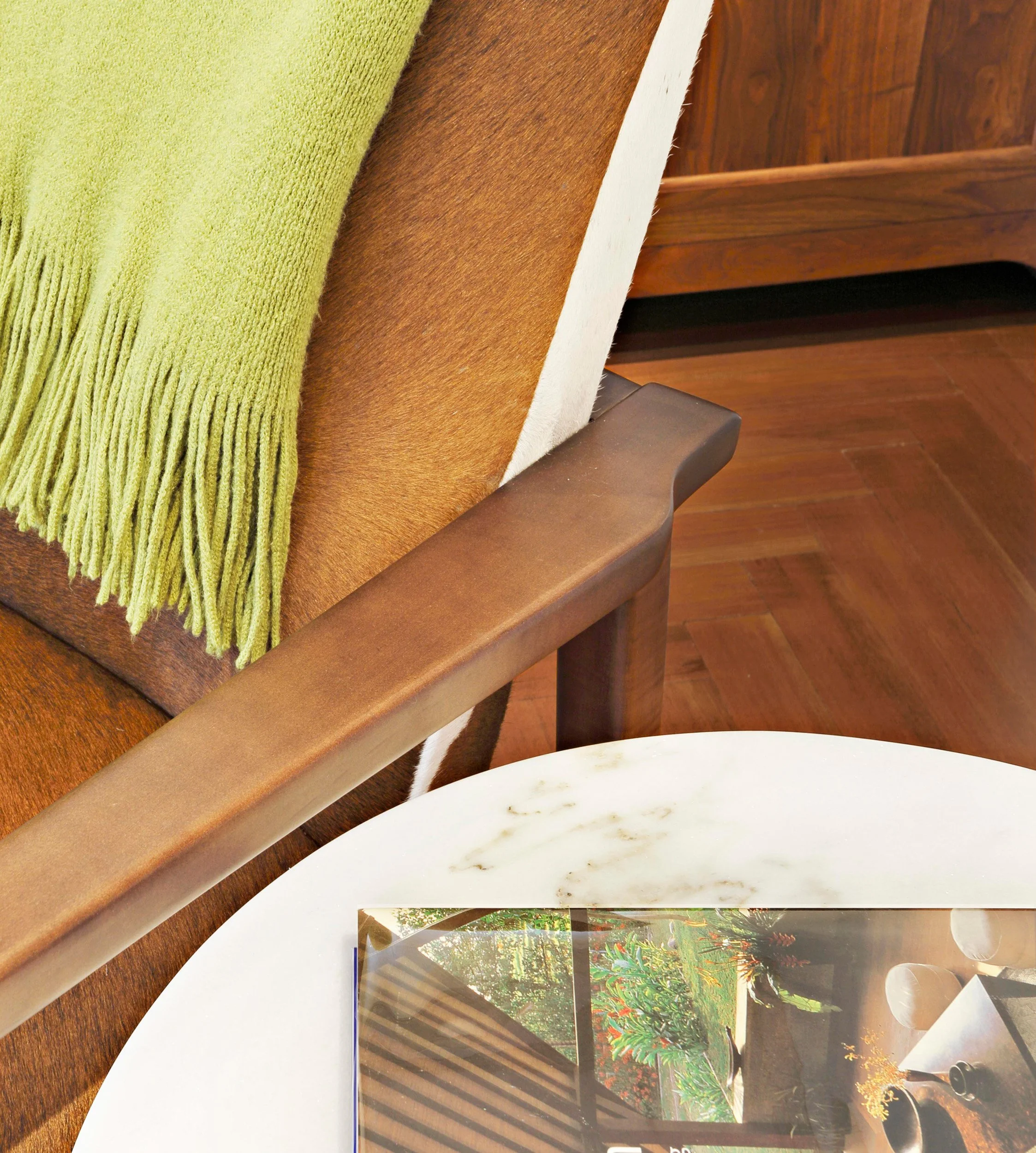 Close-up of accent chair paired with side table in family room seating area of Indian Field residence in Greenwich, CT.