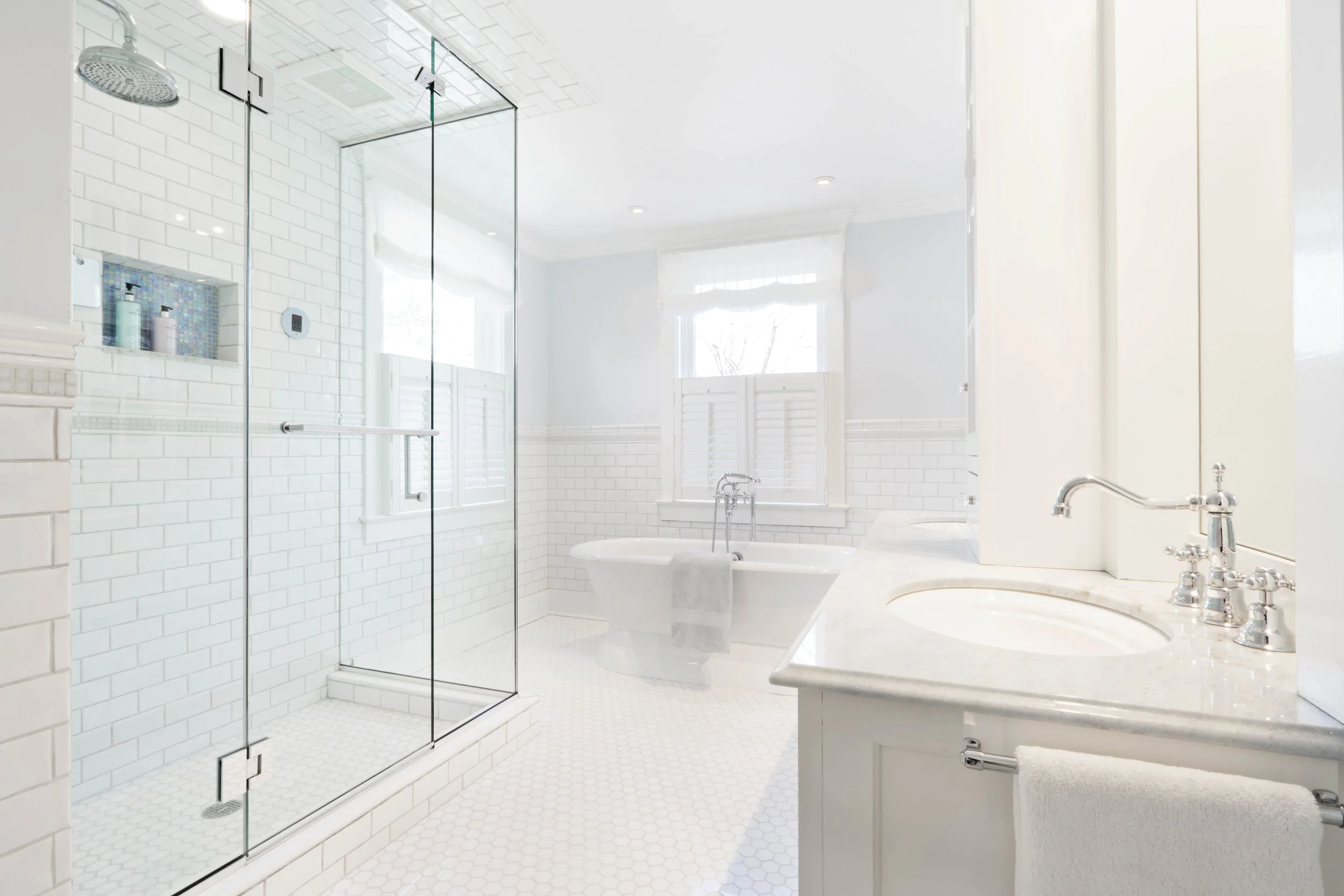 Wide view of primary bathroom with freestanding tub and steam shower.