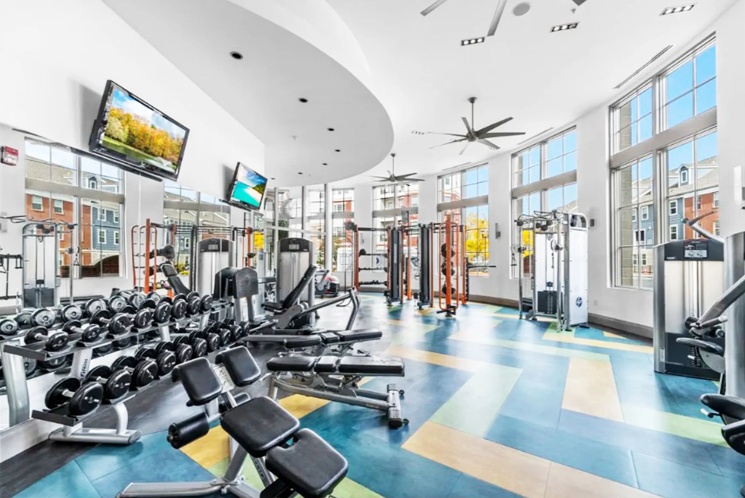 Gym for Castle Lantera, Bayonne NJ featuring herringbone gym floor designed by Luminosus Designs.
