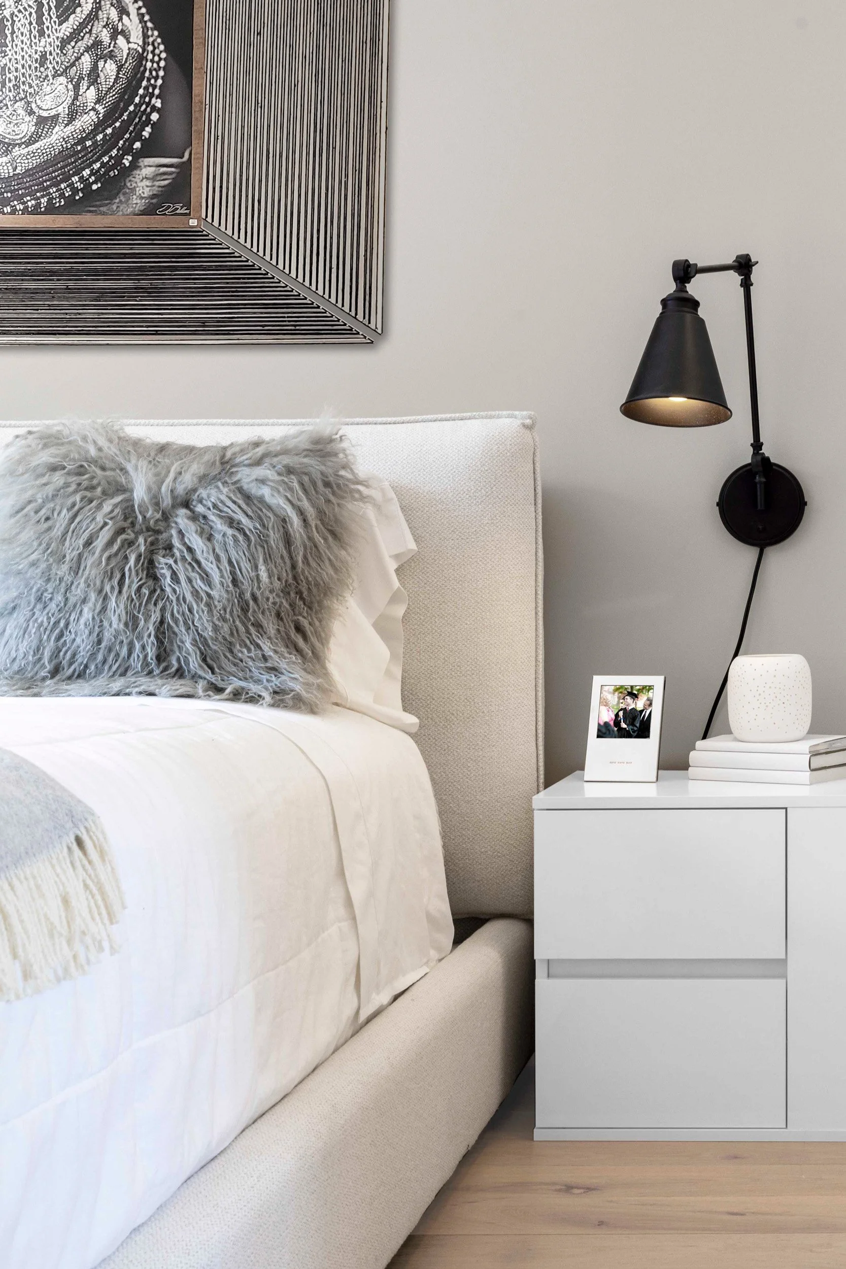 Close-up of the headboard and layered bedding in the Gramercy Arms NYC sleeping alcove.