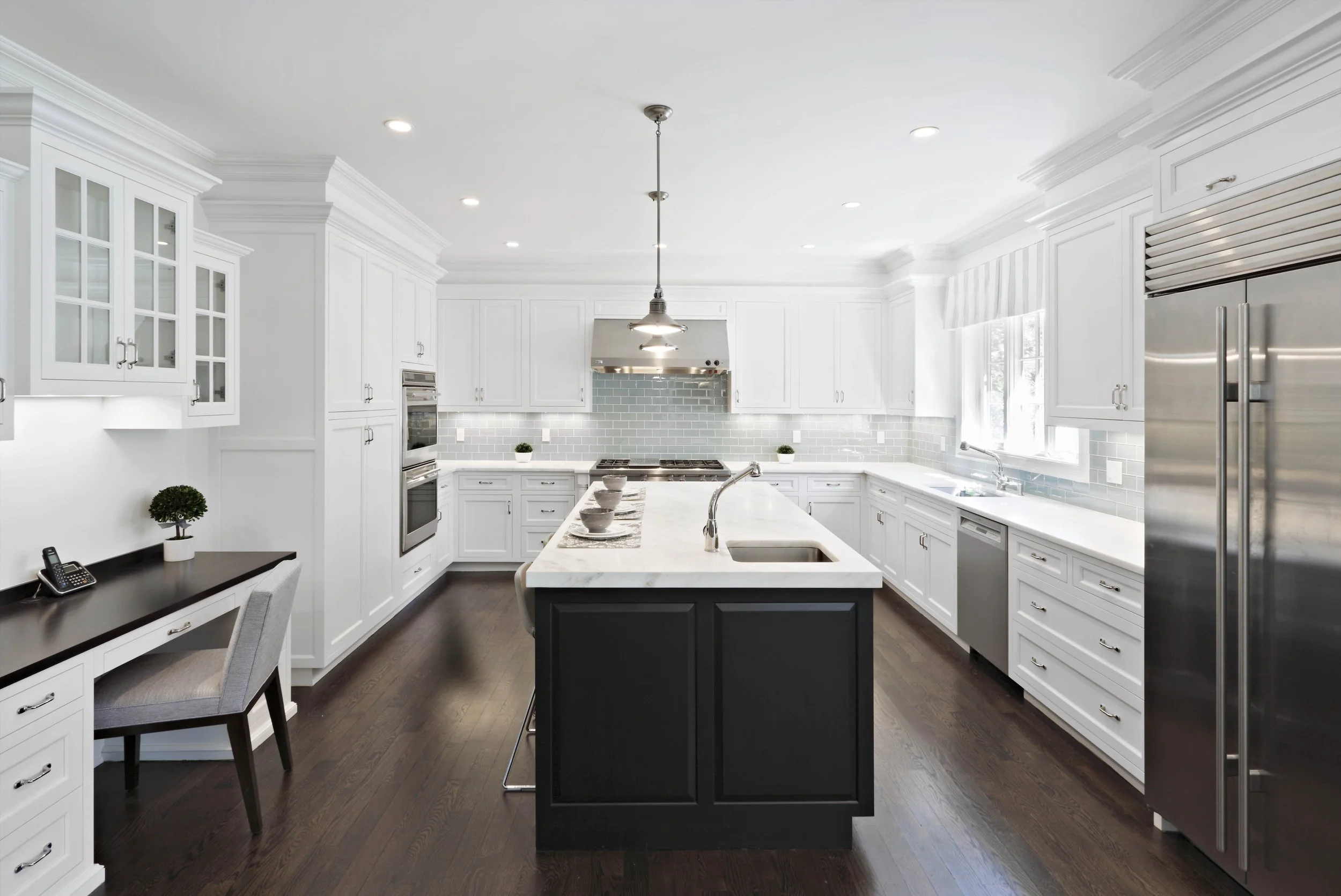 Kitchen in Parkfield House in Scarsdale NY home with large island by Luminosus Designs.