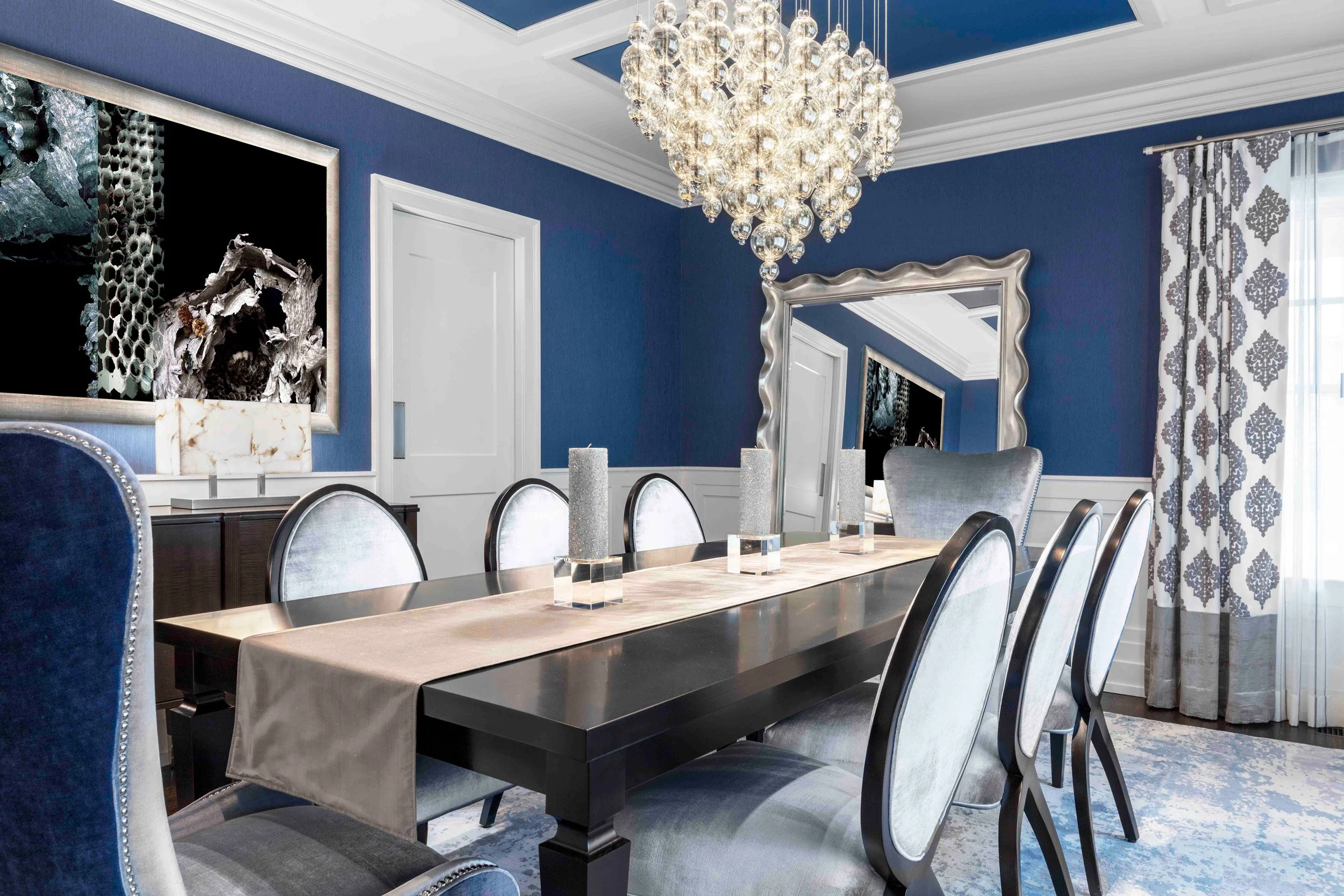 Close-up view of the Glen Oaks dining room in Rye, New York, showcasing layered lighting, custom furnishings, and a refined palette designed by Luminosus Designs.