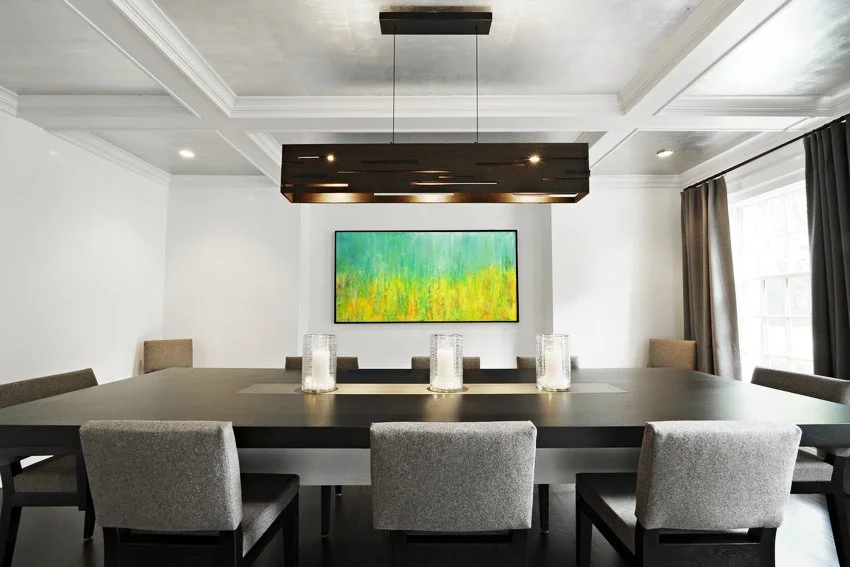 Dining room at the Meeting House in Greenwich, CT featuring a custom dark wood table and contemporary linear chandelier designed by Luminosus Designs.