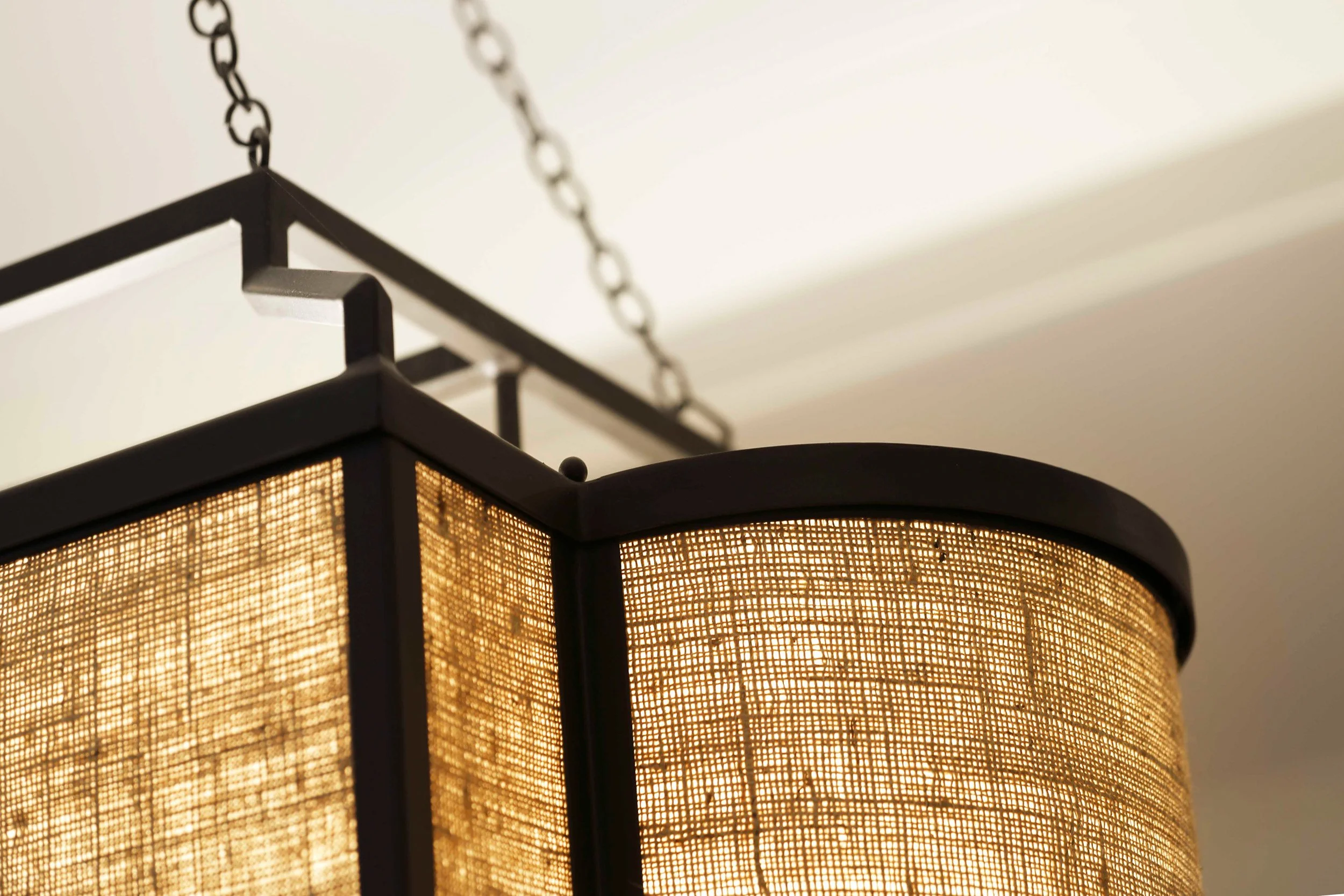 Close-up of sculptural chandelier anchoring the dining room seating area in Indian Field residence in Greenwich, CT.
