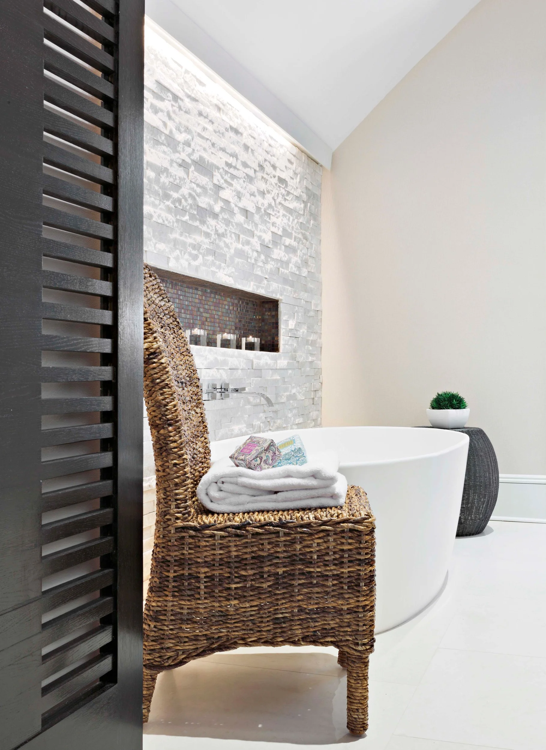 close-up view of the serene soaking tub with wall mount tub filler in a primary bathroom in Old Briarcliff, NY.