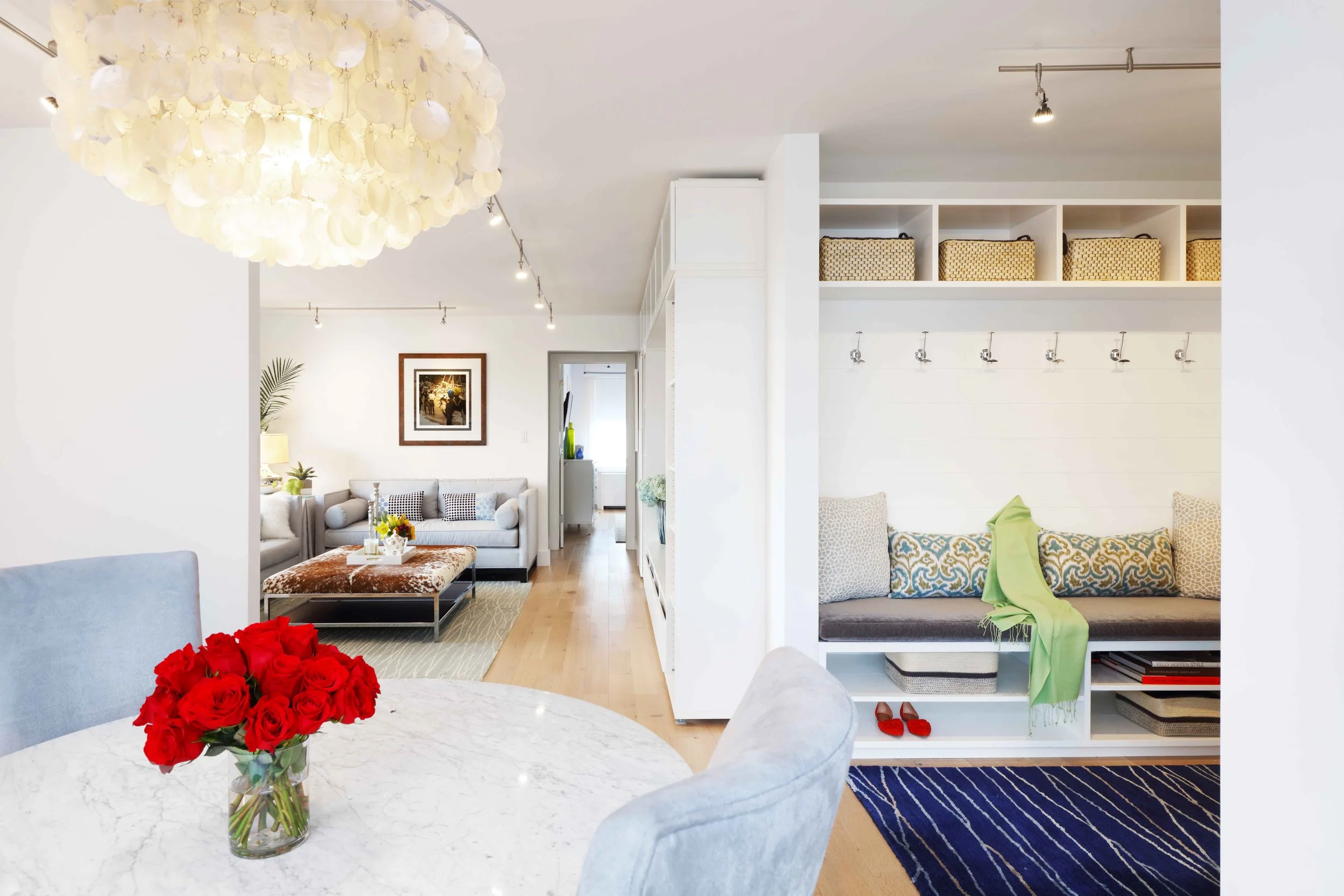 Dining area featuring a clean-lined table with modern seating in a light-filled apartment in Doyer Apartment in White Plains, NY.