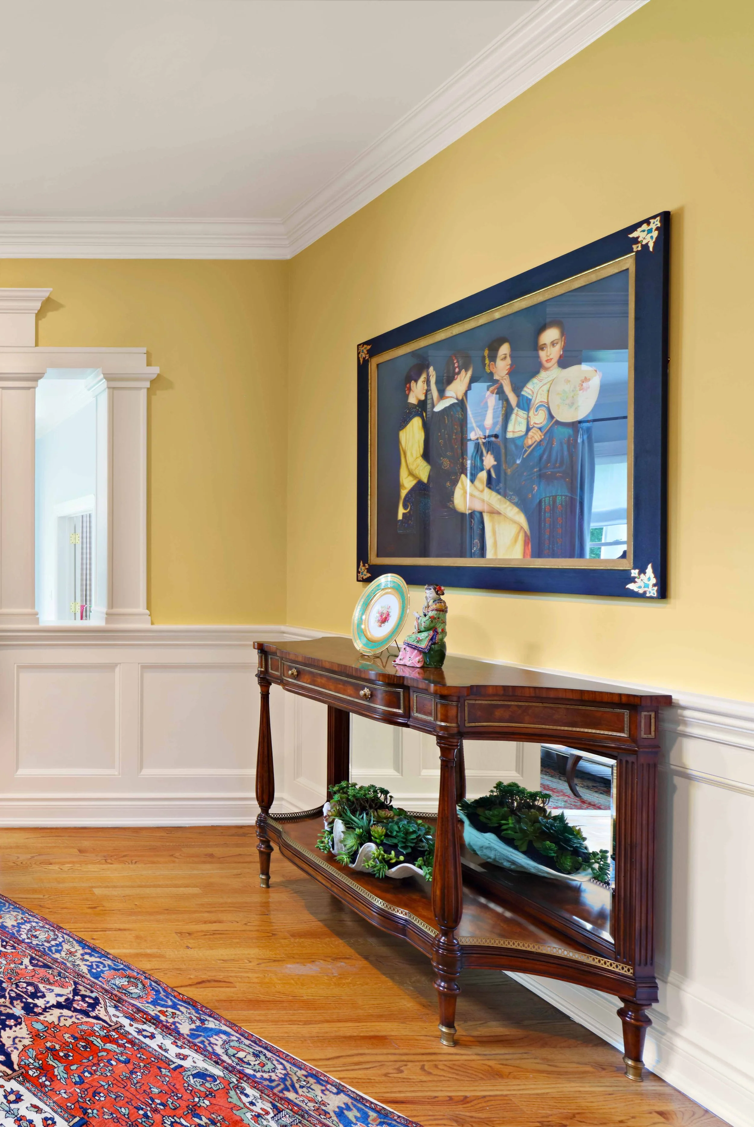 Foyer featuring console table and artwork at Lismore House in Greenwich, CT.
