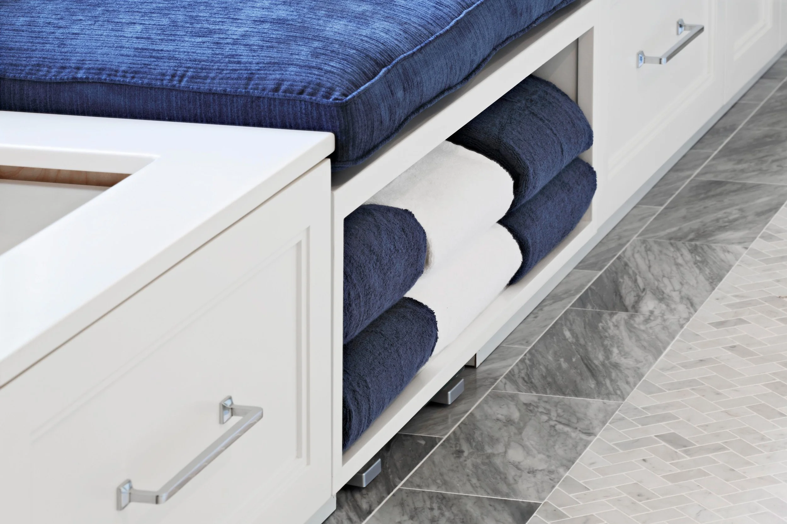 Close-up of a built-in bathroom bench with integrated laundry hamper in a Jack and Jack bathroom at the Dann Farm residence in Pound Ridge, NY.