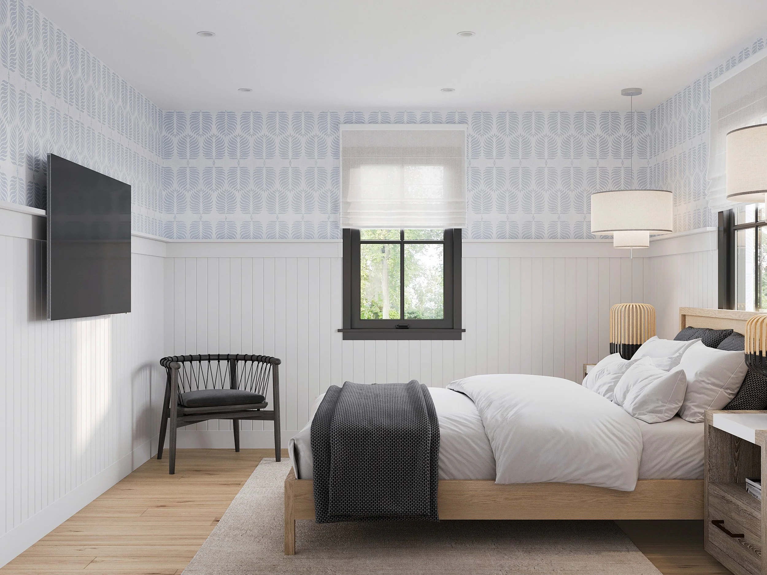 Wide view of guest bedroom with wall-mount TV and side chair in Nanny Hagen House in Thornwood, NY.