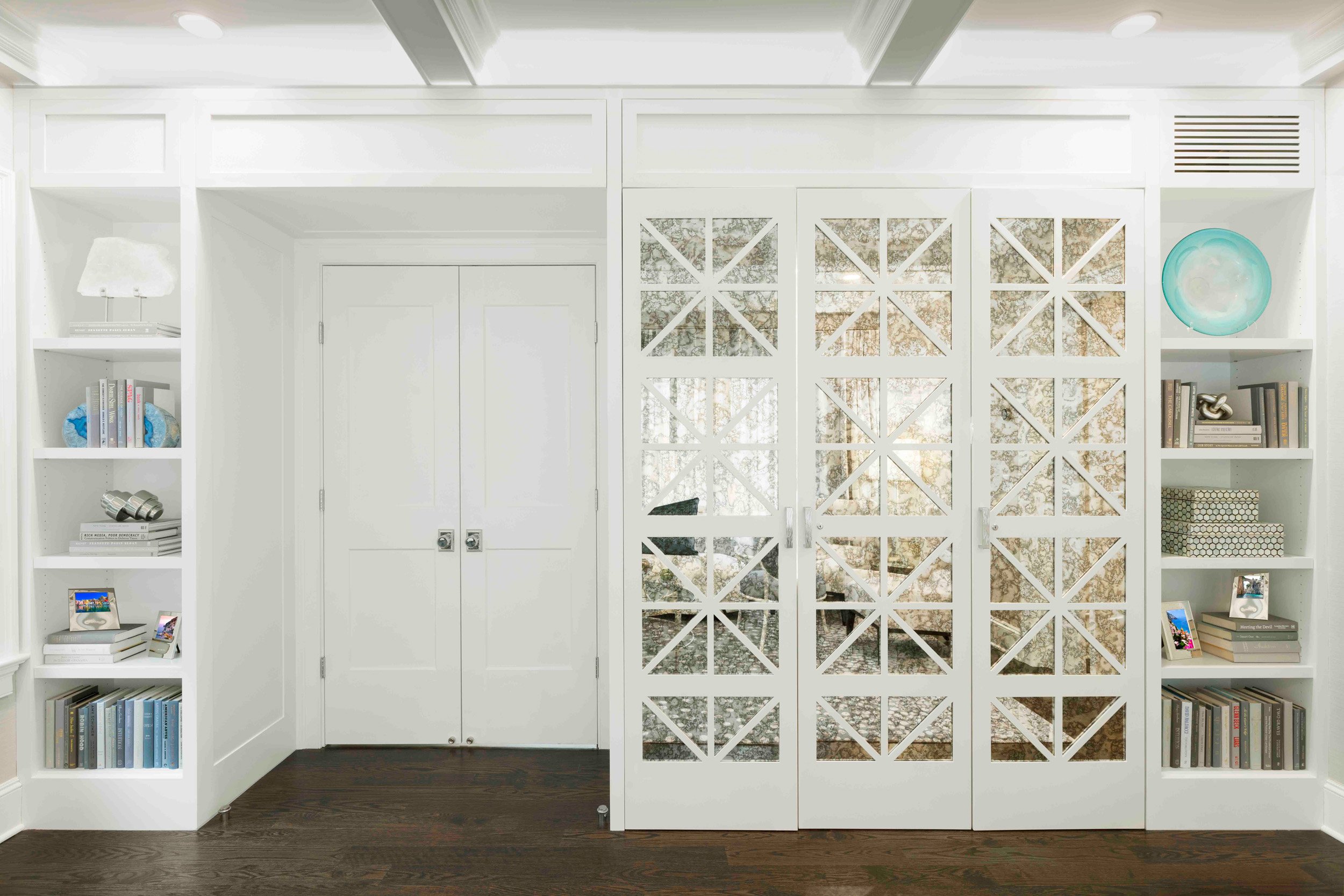 Close-up view of the custom bookcase and hidden bar cabinet in the Glen Oaks, Rye, NY living room, showing surround and finish details.
