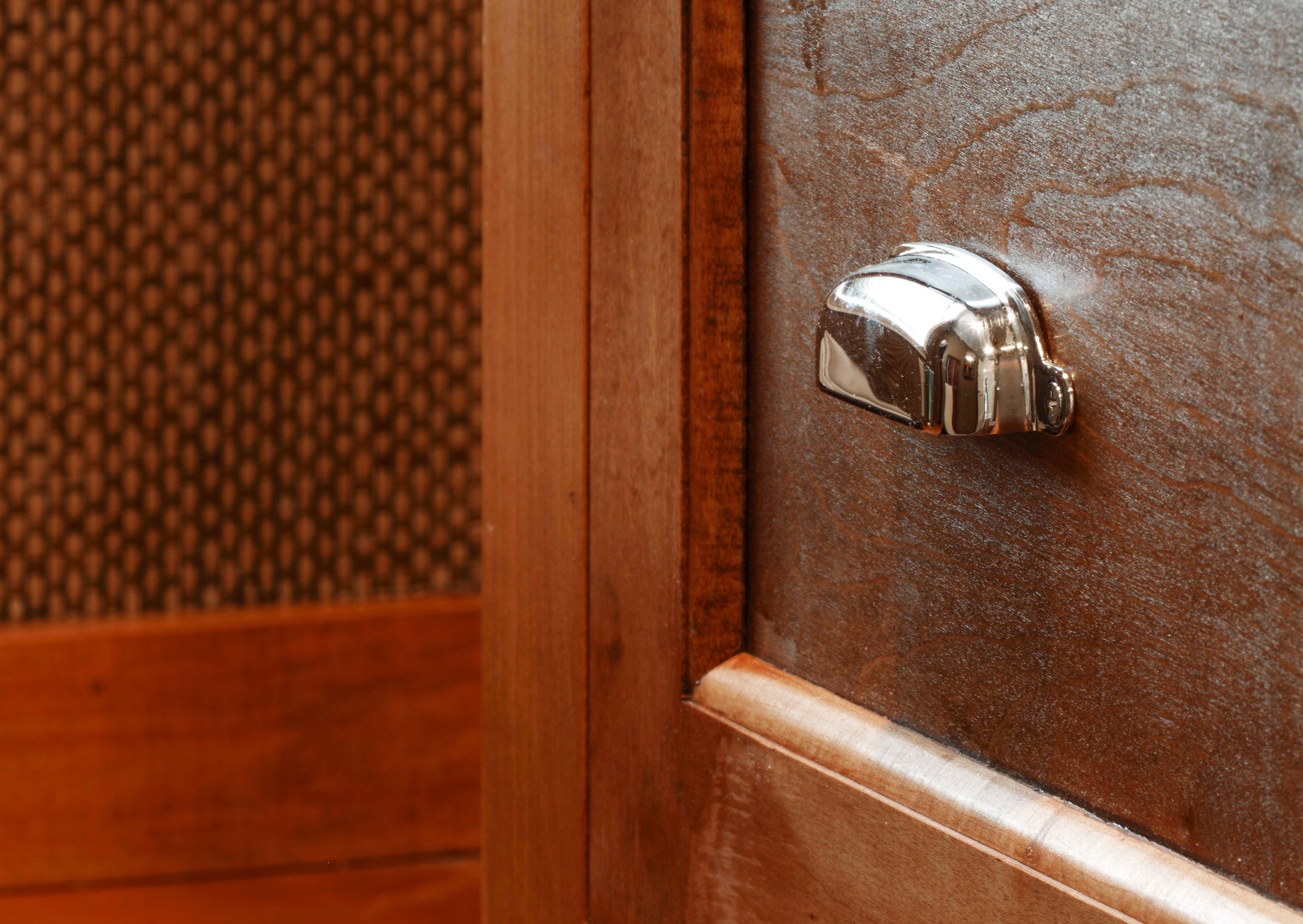 Close-up of custom closet hardware and finish detailing in His closet in Greenwich, CT.