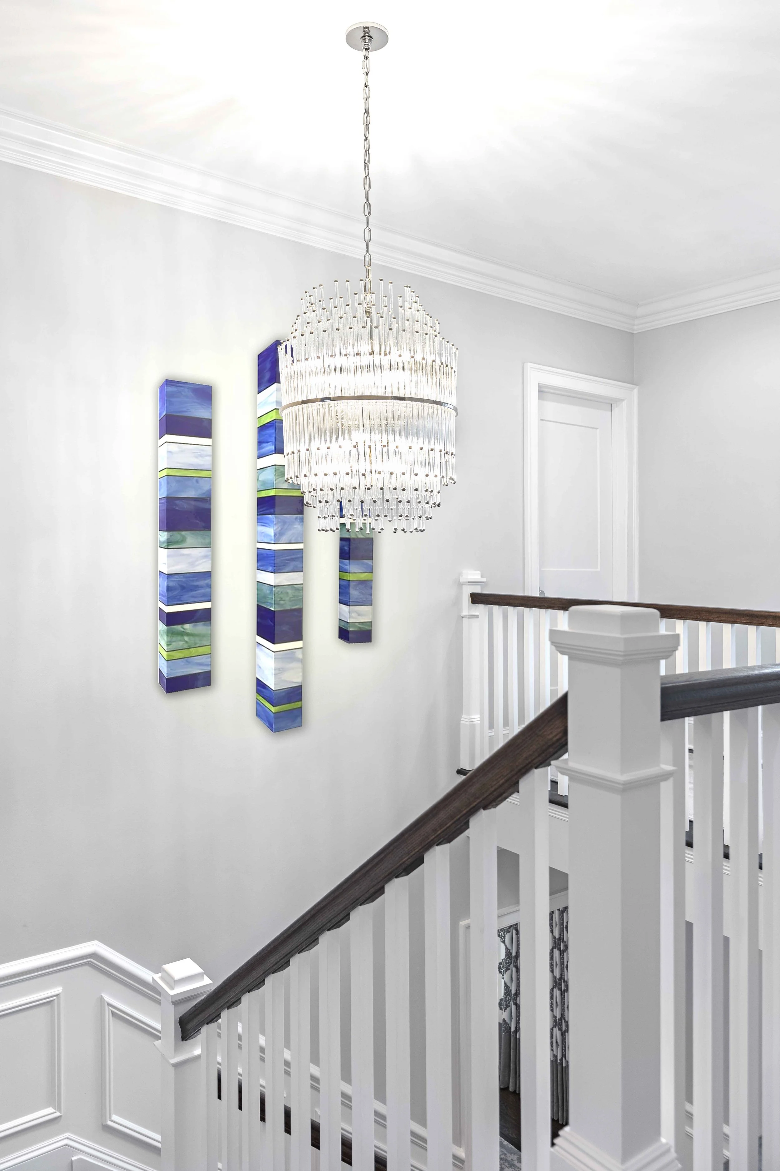 Close-up view of the staircase chandelier in the Glen Oaks, Rye NY home, highlighting craftsmanship and materials.