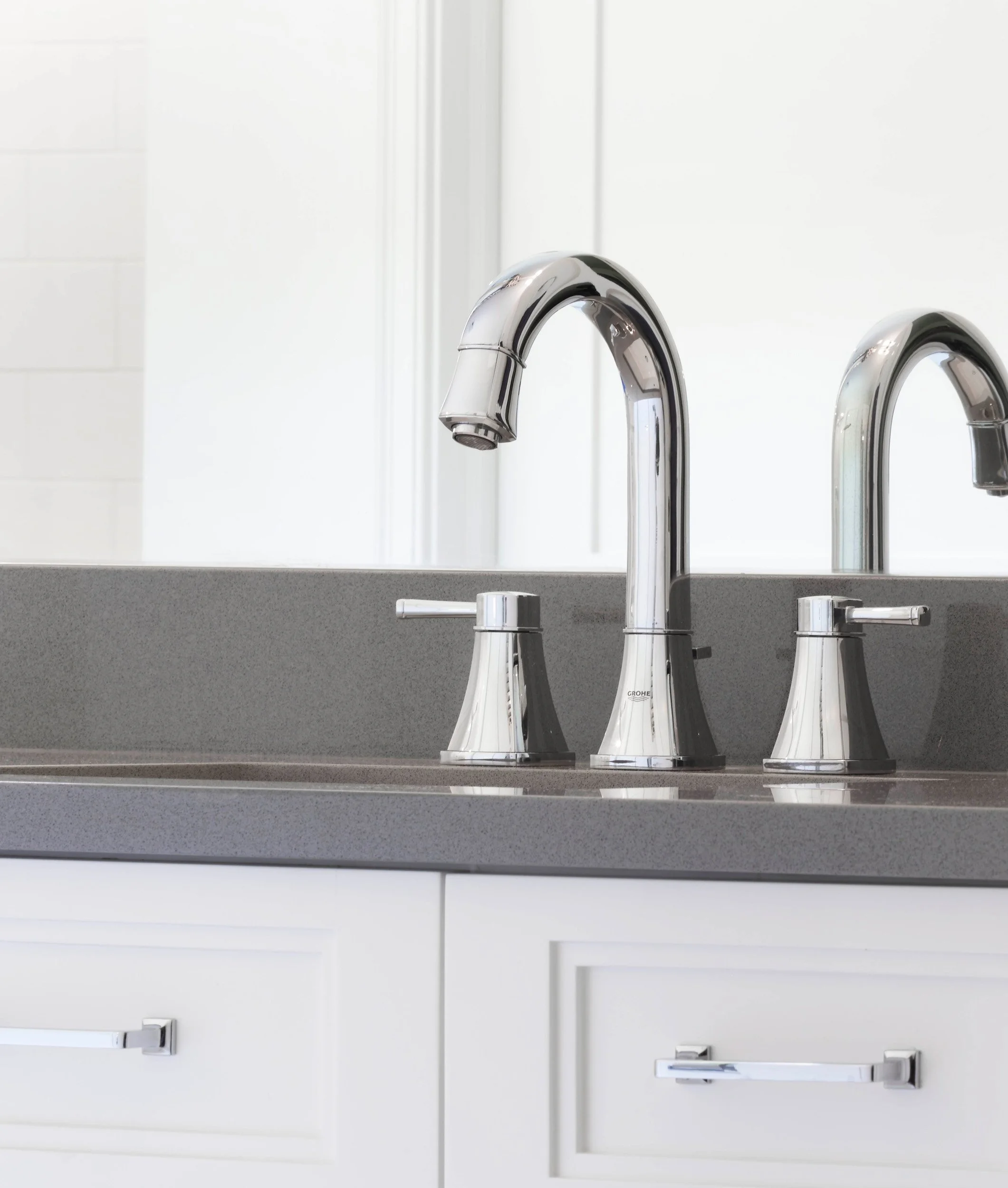 Close-up of a polished chrome vanity faucet and quartz countertop in a Jack and Jack bathroom at the Dann Farm home in Pound Ridge, NY.