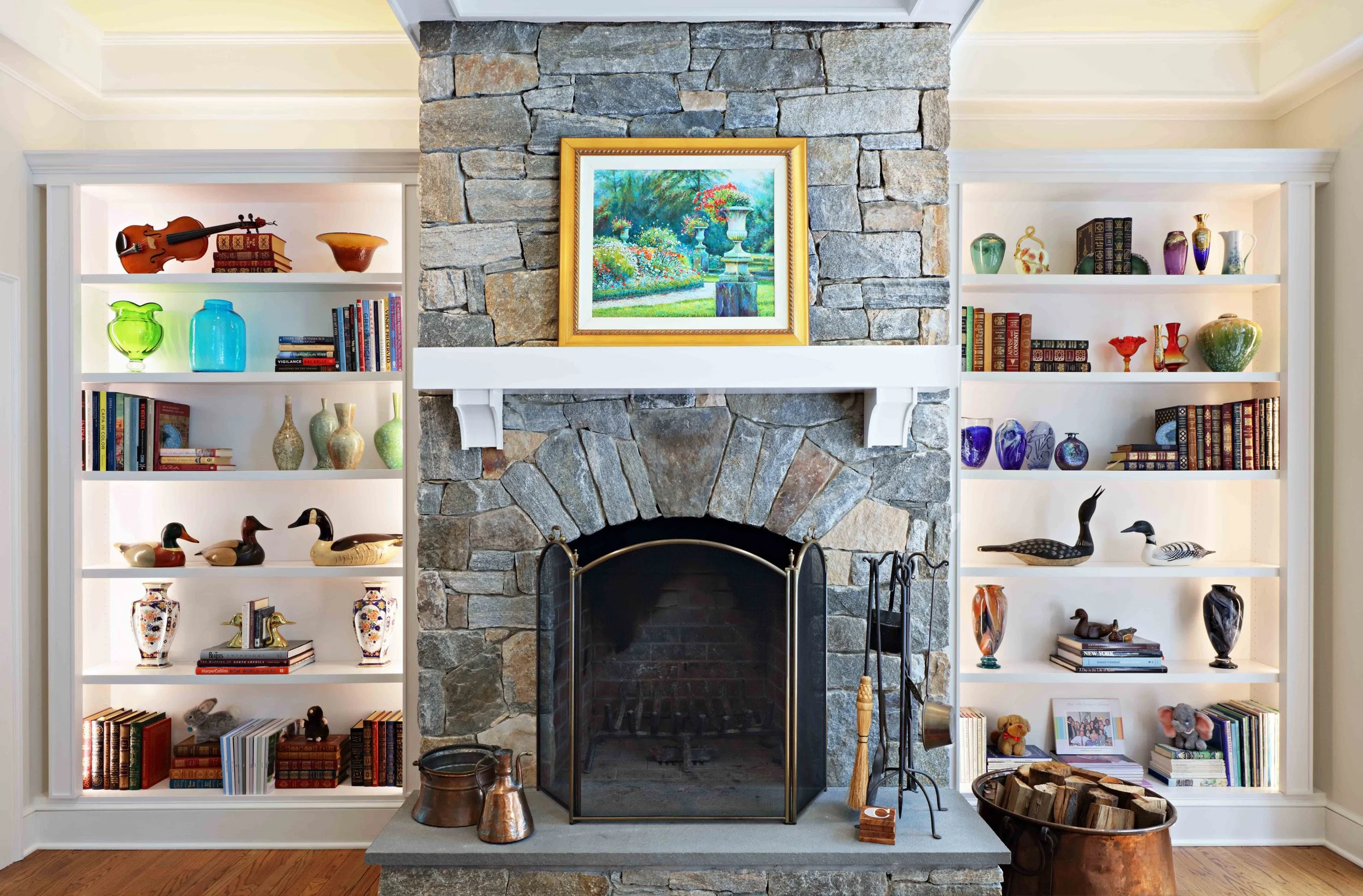 Family Room featuring stone fireplace and built-ins at Lismore House in Greenwich, CT.