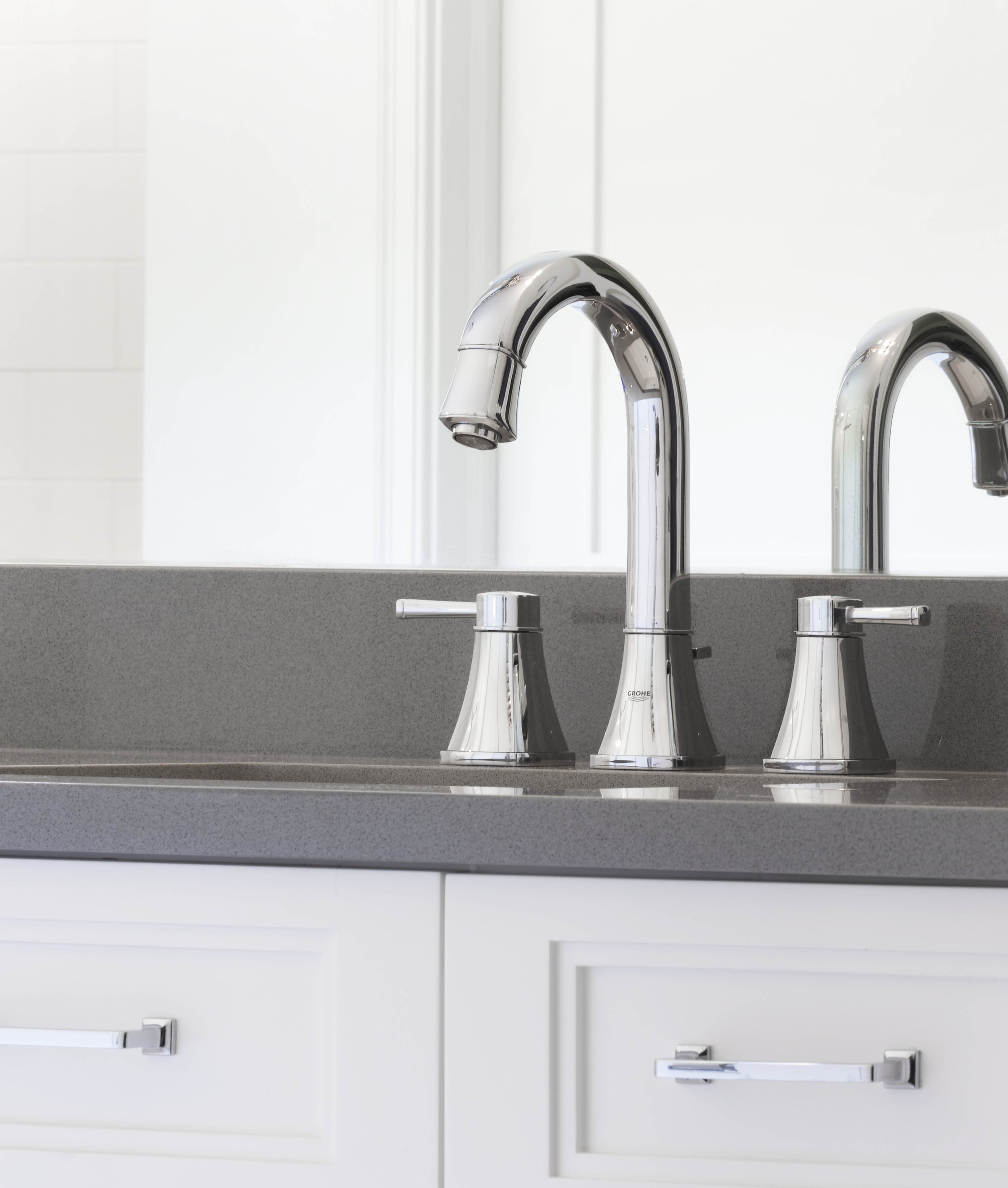 Close-up of a polished chrome vanity faucet and quartz countertop in a Jack and Jack bathroom at the Dann Farm home in Pound Ridge, NY.