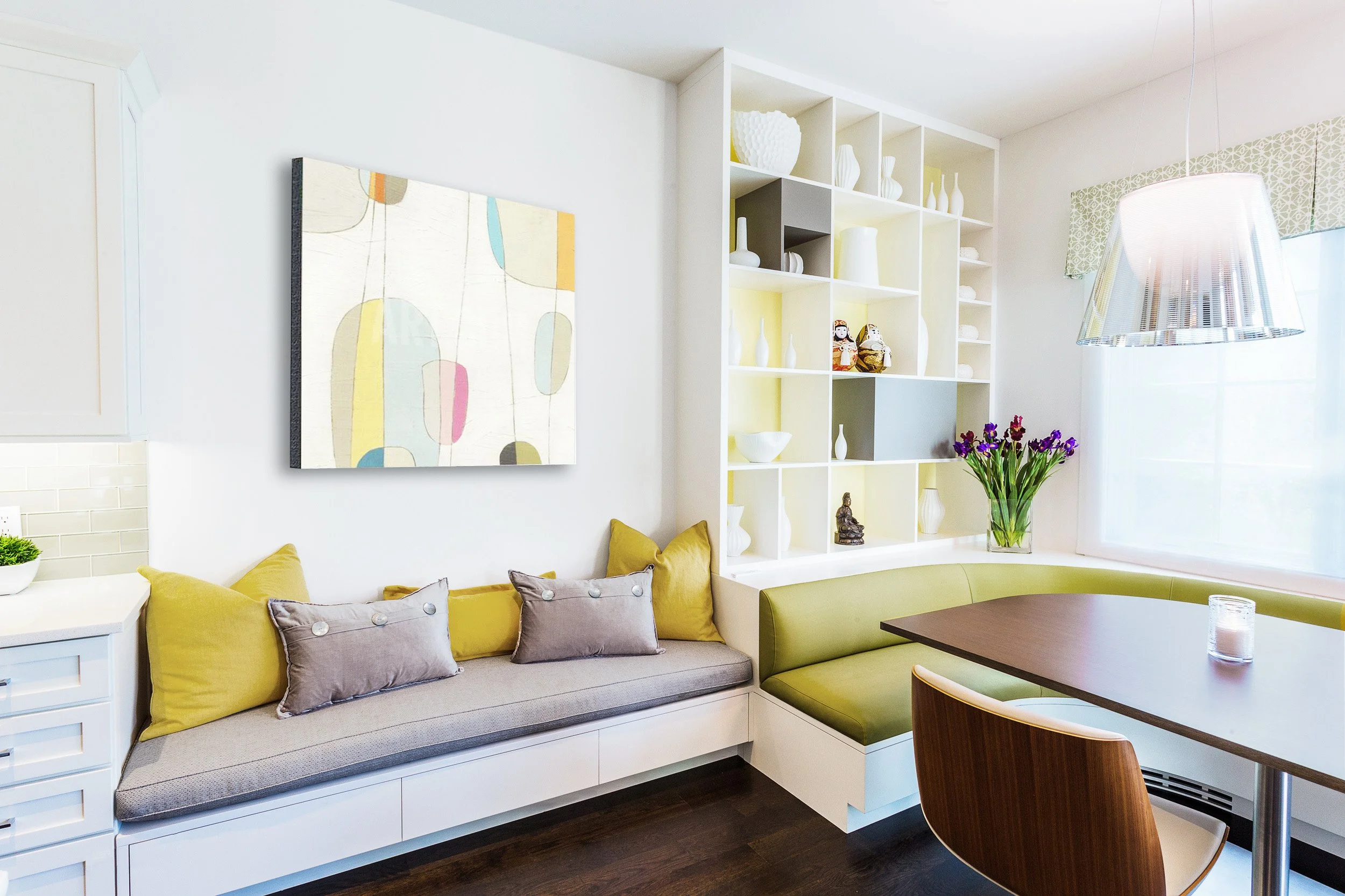 Close-up of the breakfast banquette and built-in display shelving with chrome pendant lighting and layered accessories in Kensett House in Darien, CT. 