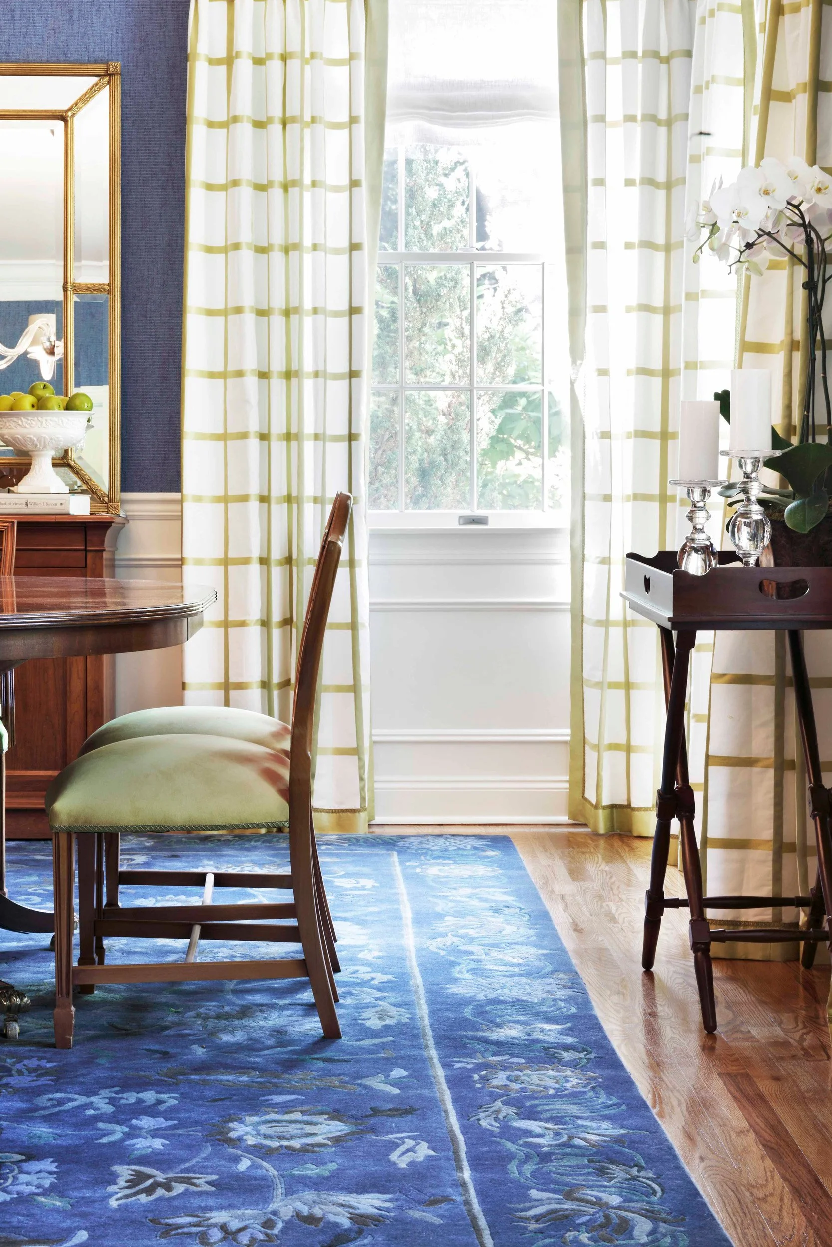 Close-up of custom window treatments and upholstered dining chair in a formal dining room at the Dann Farm residence in Pound Ridge, NY designed by Luminosus Designs.
