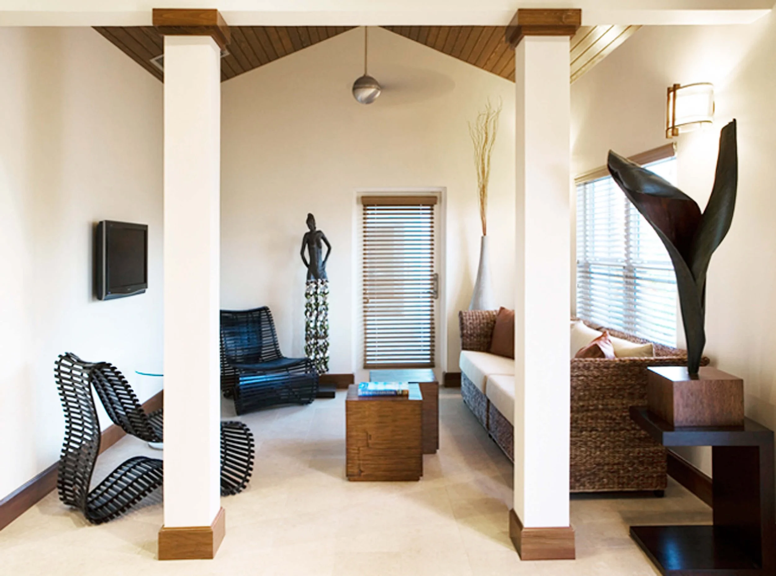 Reception seating area at Cotton Tree Grand Cayman with natural materials and coastal styling.