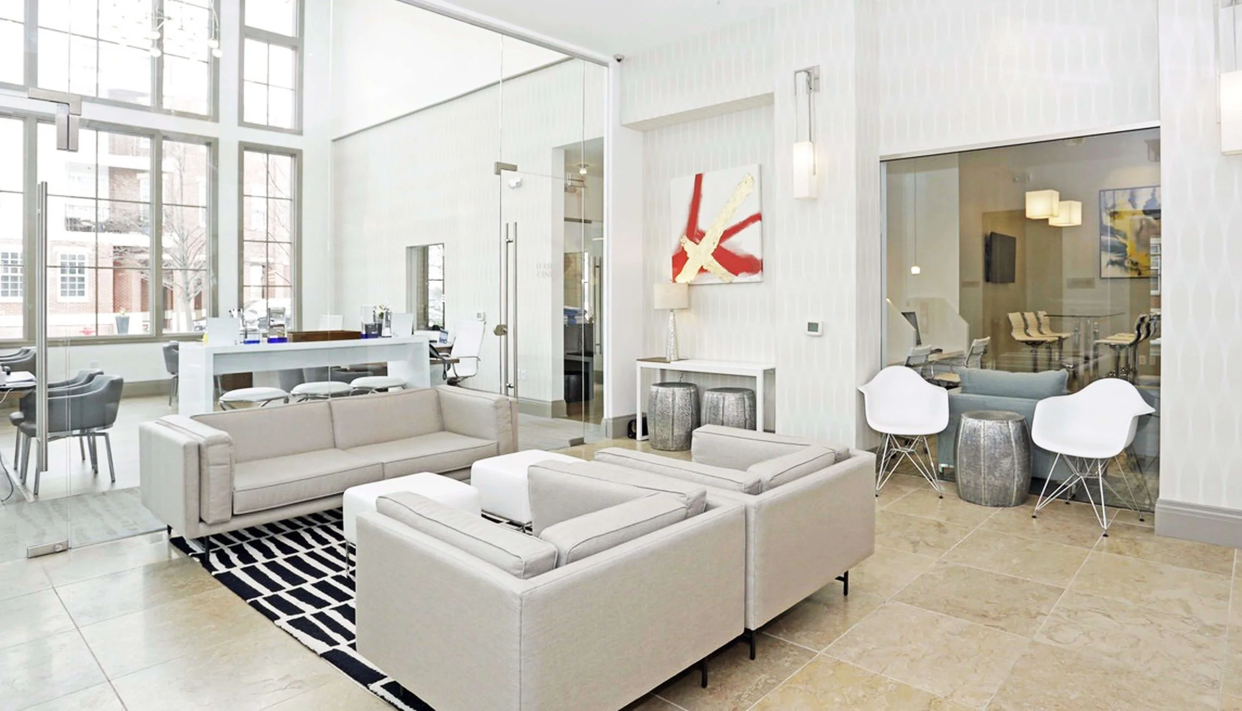 Leasing office interior design for apartment building in Bayonne NJ with modern furniture and neutral palette.