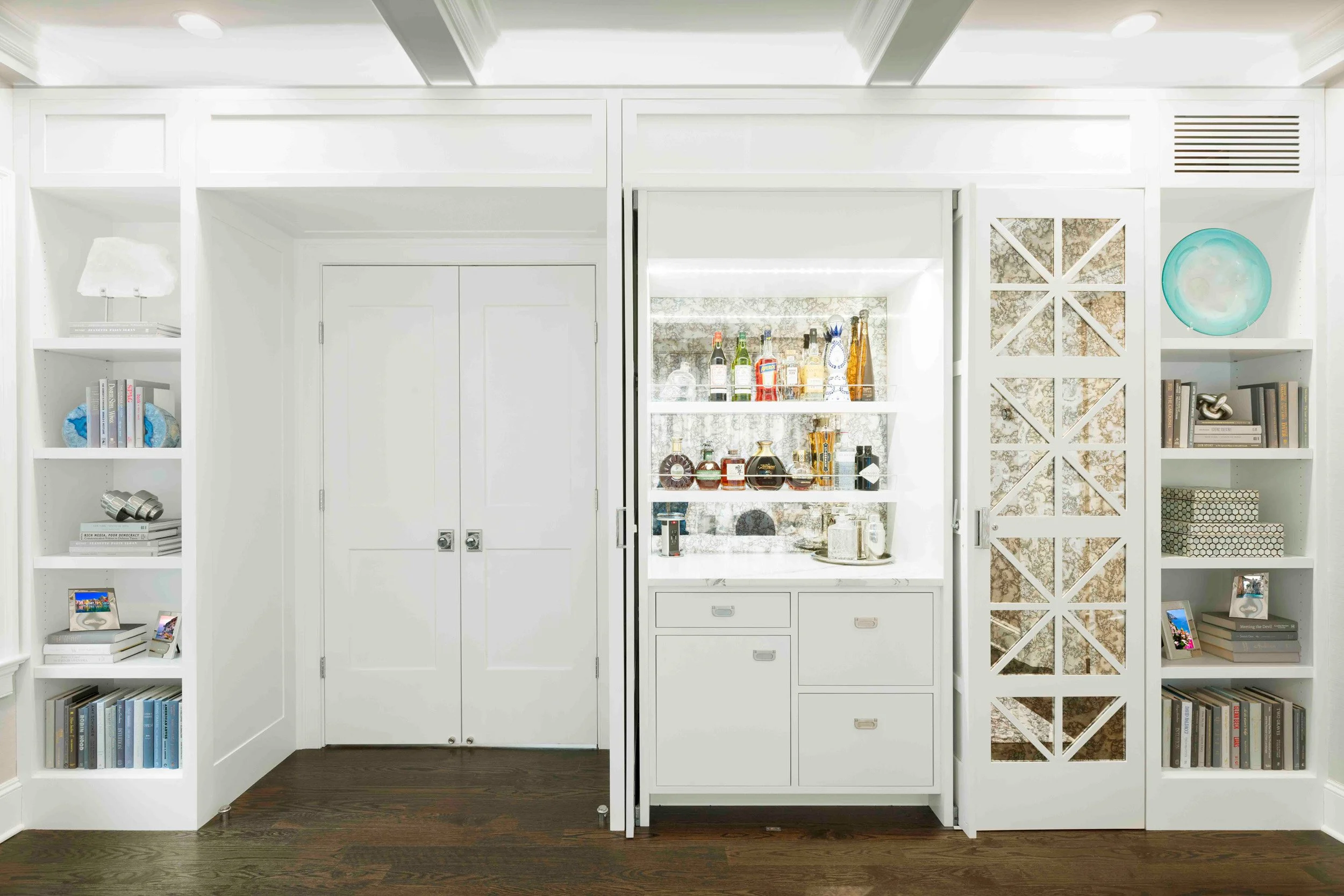 Alternateview of the custom bookcase and bar cabinet in the Glen Oaks, Rye, NY living room, showing surround and finish details.