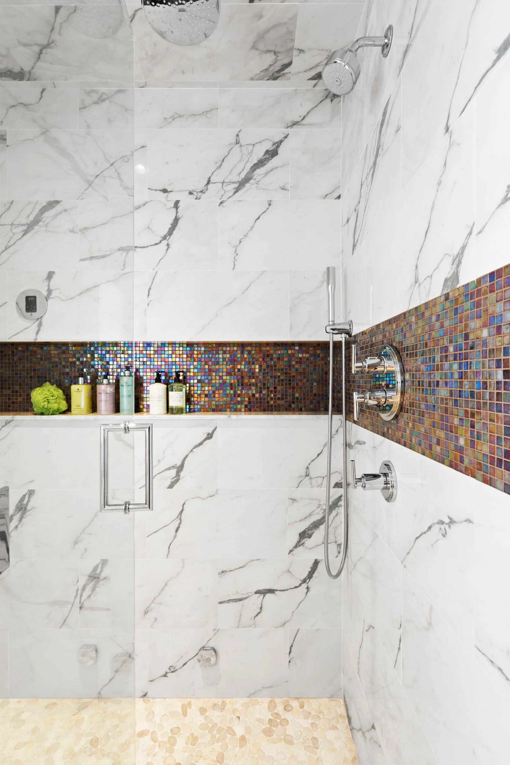 close-up view of the shower niche and mosaic accent tile in a primary bathroom in Old Briarcliff, NY.