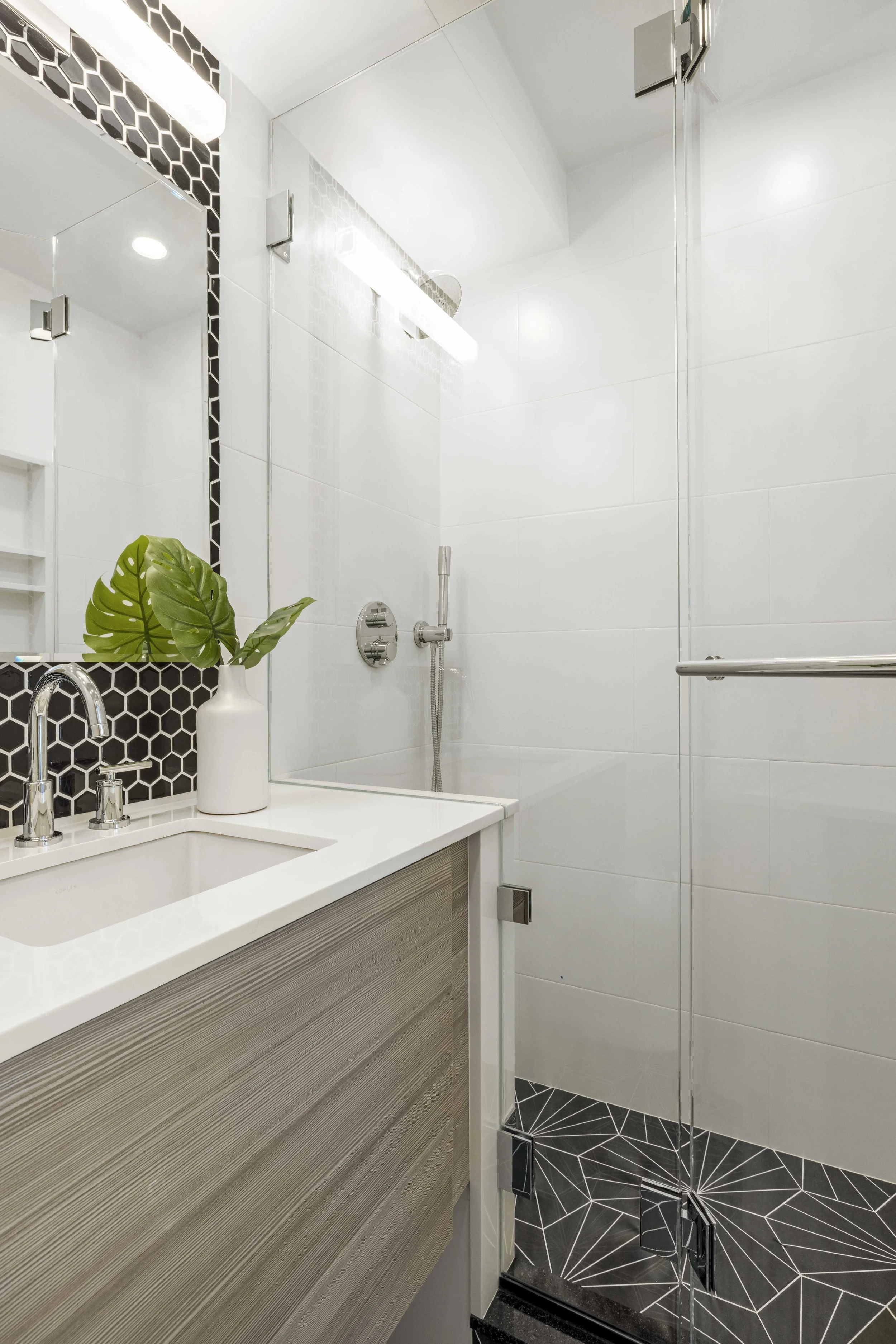 Close-up of the bathroom vanity and shower in the Gramercy Arms apartment, NYC by Luminosus Designs.