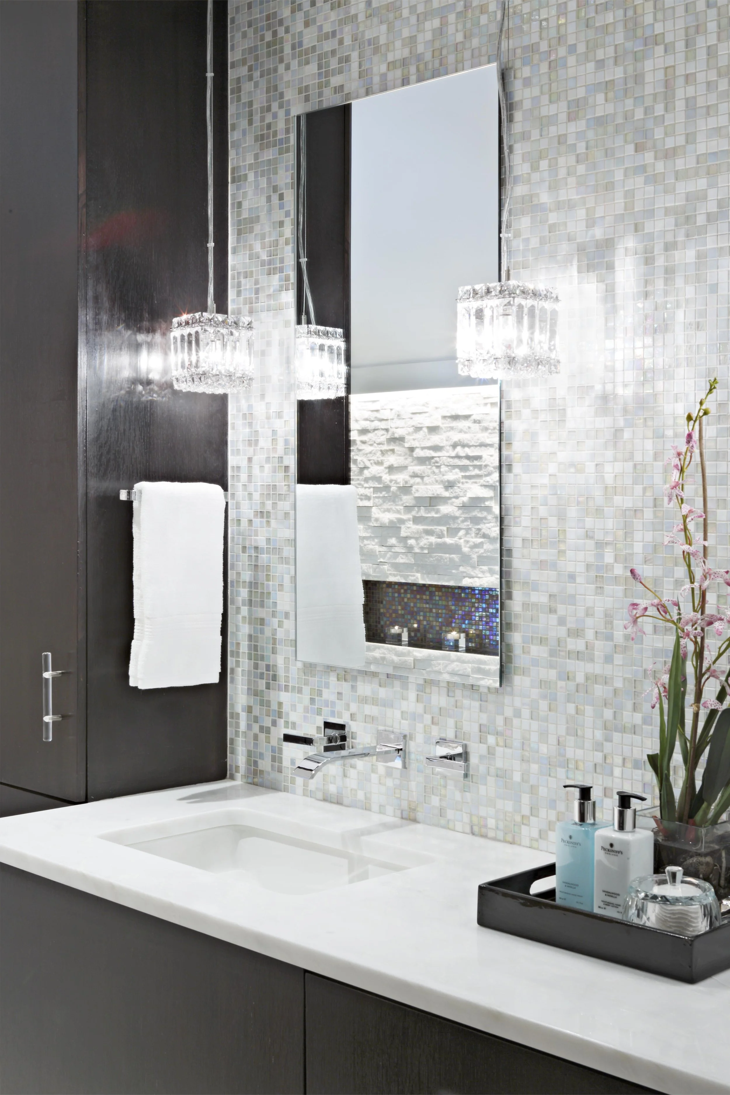 close-up view of the custom vanity mirror and tile in a primary bathroom in Old Briarcliff, NY, designed by Luminosus Designs.