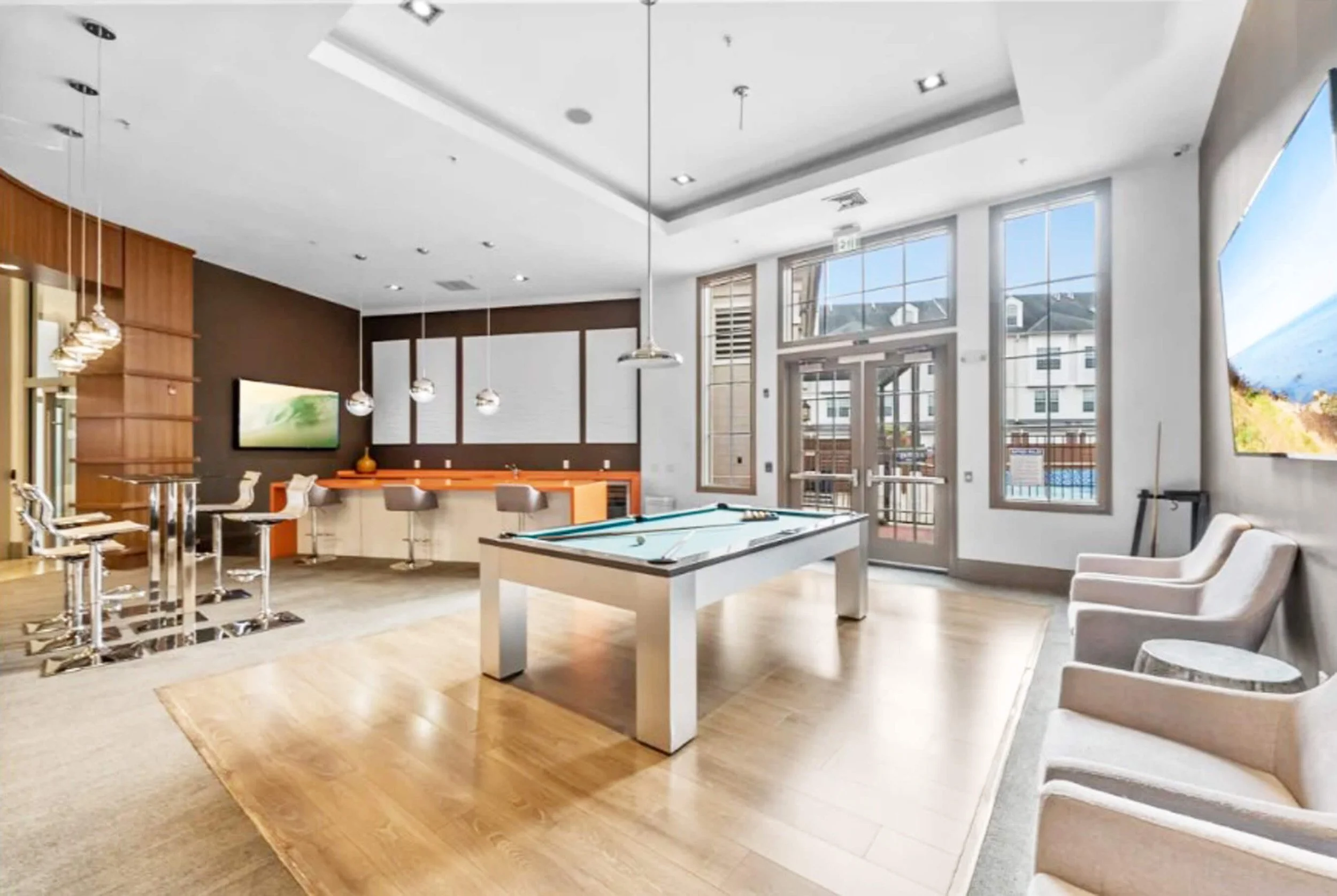 Shared residential lounge space with modern furnishings in Bayonne NJ apartment building.