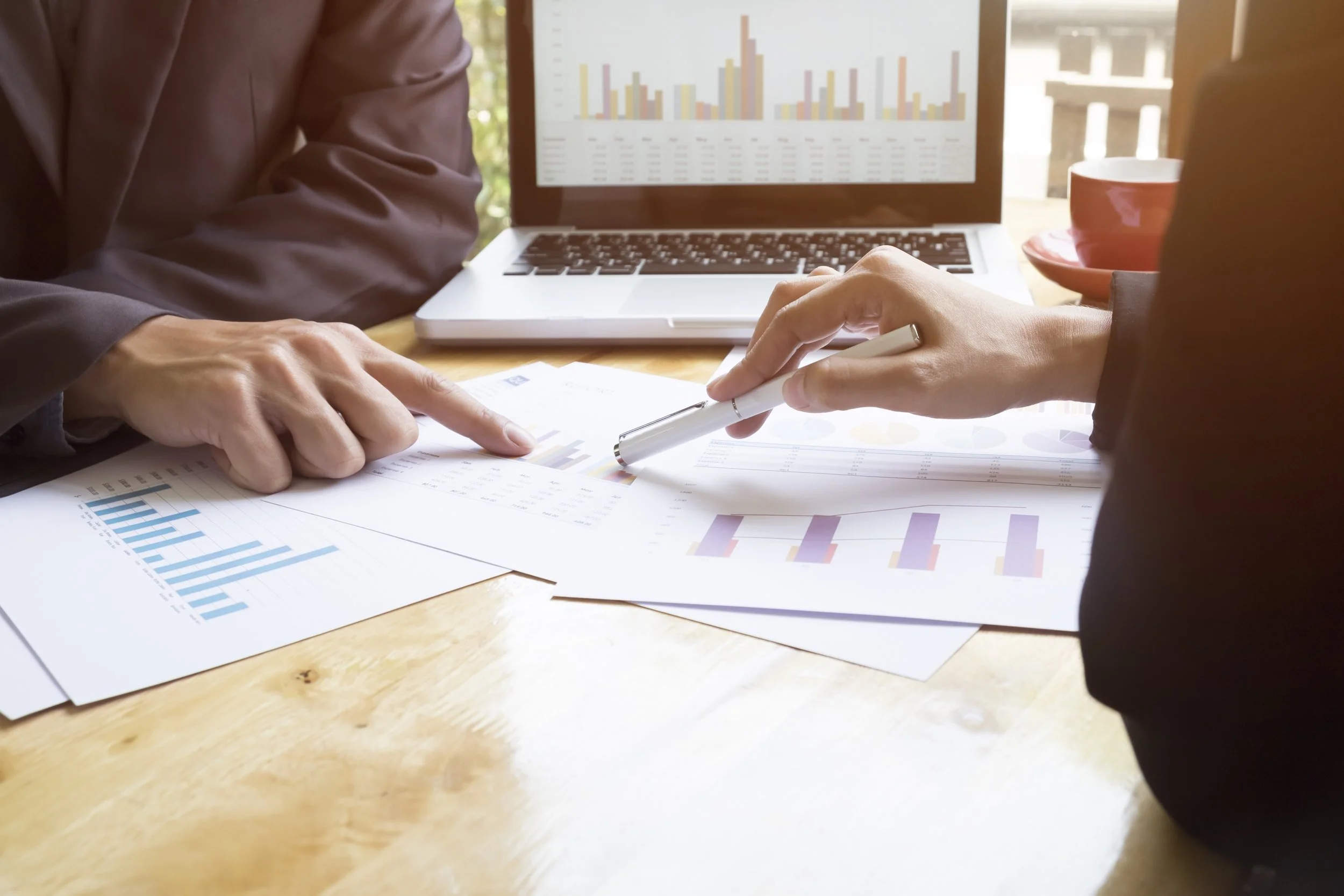 two people working with spreadsheets