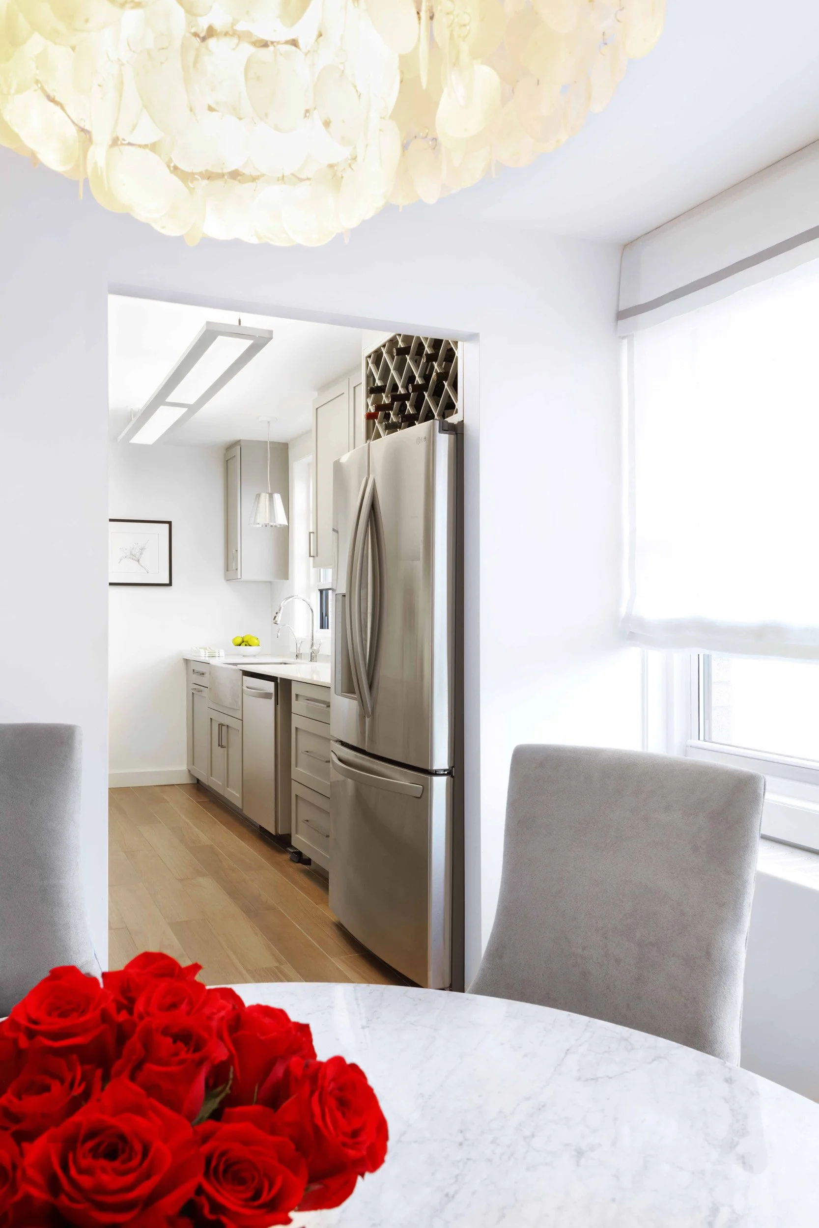 Dining room detail highlighting streamlined chairs and refined finishes in Doyer Apartment in White Plains, NY.